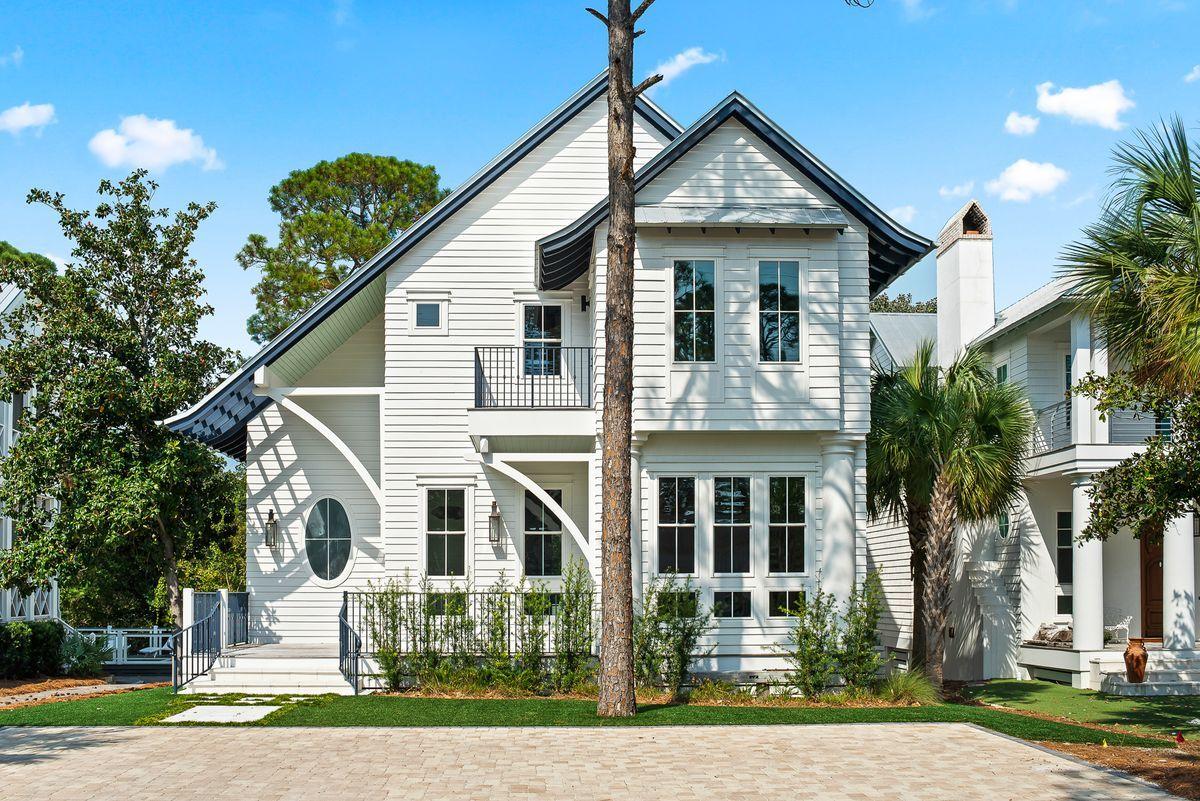 Just a few blocks from white sand beaches, this custom coastal home has been professionally designed and features several modern finishes. A 10 ft front door leads into an open living area with wood flooring, contemporary light fixtures, 12 ft ceilings, reclaimed wood doors, and shiplap walls. The slate tile fireplace in the living room is a unique focal point, and a spacious dining area and breakfast bar are perfect for large gatherings. The gourmet kitchen features Electrolux appliances, two dishwashers, a seamless slate tile backsplash, granite countertops, and soft close cabinets and drawers. Wet bar areas both downstairs and upstairs allow for easily preparing and serving cocktails.