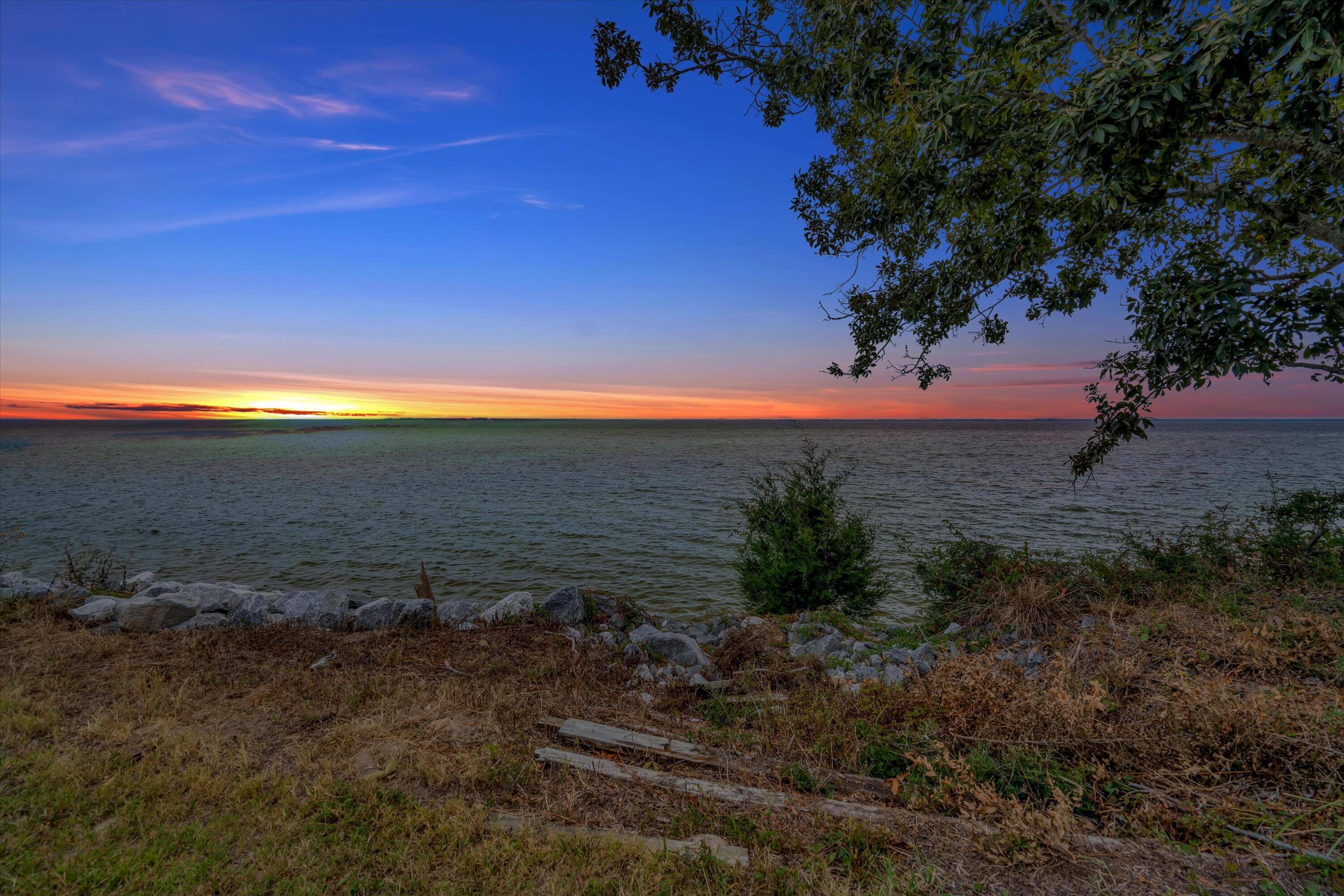 Enjoy the waterviews from this DEEDED bayfront home in Choctaw Beach! Built in 2020 on .51 acres, this spacious home features 2305sf with all the bells and whistles: leather granite in the kitchen, ample soft-close gray cabinets, upgraded Samsung Black stainless steel appliances, LVP flooring throughout. Open concept living with split 3 bedrooms plus office behind double french doors AND a bonus room also behind double french doors. All the advantages of a new build, with lower insurance, hurricane impact windows, Trex decking, 2 upgraded attic storage areas, full house ethernet plus built-in security system. Oversized garage is on the back of the home along with a fenced backyard. Bayfront parcel to boat from, never use a trailer or pay to store your