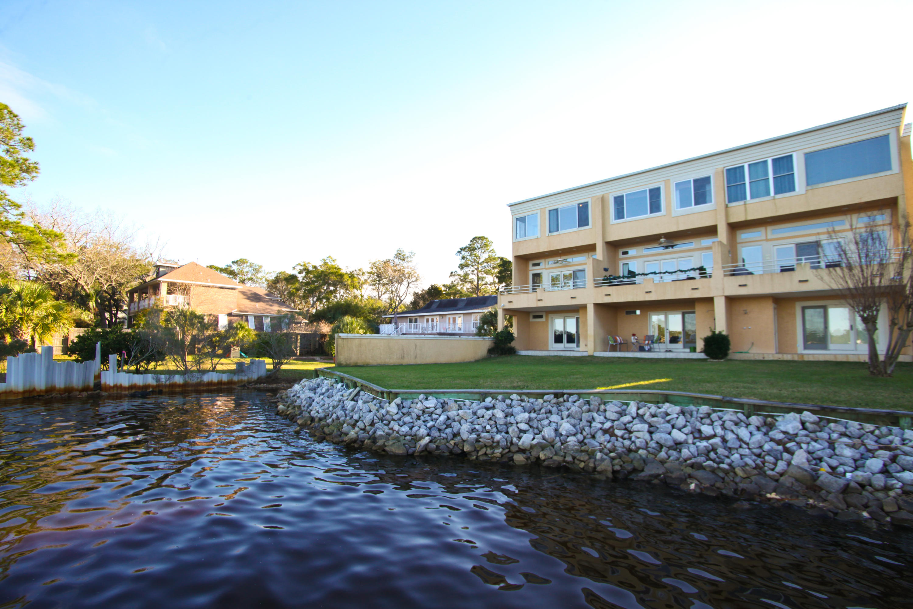 Don't wait another minute to see this waterfront townhome with 3 bedrooms and 3.5 baths. Complex features paver entryway and well-maintained lawn. Complex has plenty of lawn space outside each unit. This end unit with waterfront view from back and side features 12 Foot ceilings with crown molding throughout 2nd and 3rd floors. Large master suite with looking bay and 2nd bedroom with it's own bath on 3rd level. Living room, kitchen, 1/2 bath and dining room on 2nd level and entry level has a private guest suite and one car garage. Lots of windows and doors for enjoying the water view from all 3 levels. Seller just installed a new Electric Hot Water Heater that cost $2000. One of the two HVAC units recently replaced. This unit has it's own dock (end) with boat lift and jet ski lift.