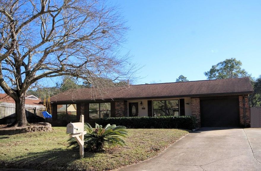 Turn-Key home in Palm Estates ready for its new owner! This Charming home offers 3 bedrooms, 2 baths, updated kitchen, HUGE screened porch, storage shed and 1-car garageat an INCREDIBLE price! The original floorplan of this home has been modified to open the living room up to the dining area and kitchen. The kitchen features updated cabinets, wood floors, breakfast bar and convenient built in table for extra seating. The roomy dining area has sliding glass doors leading to the HUGE screened porch overlooking the large back yard. There is also a covered patio area as well as an open paver patio area. The yard building in the back yard is perfect for storage so you can actually park in your garage! The roof and HVAC system were replaced in 2009 and the brick exterior means low maintenance