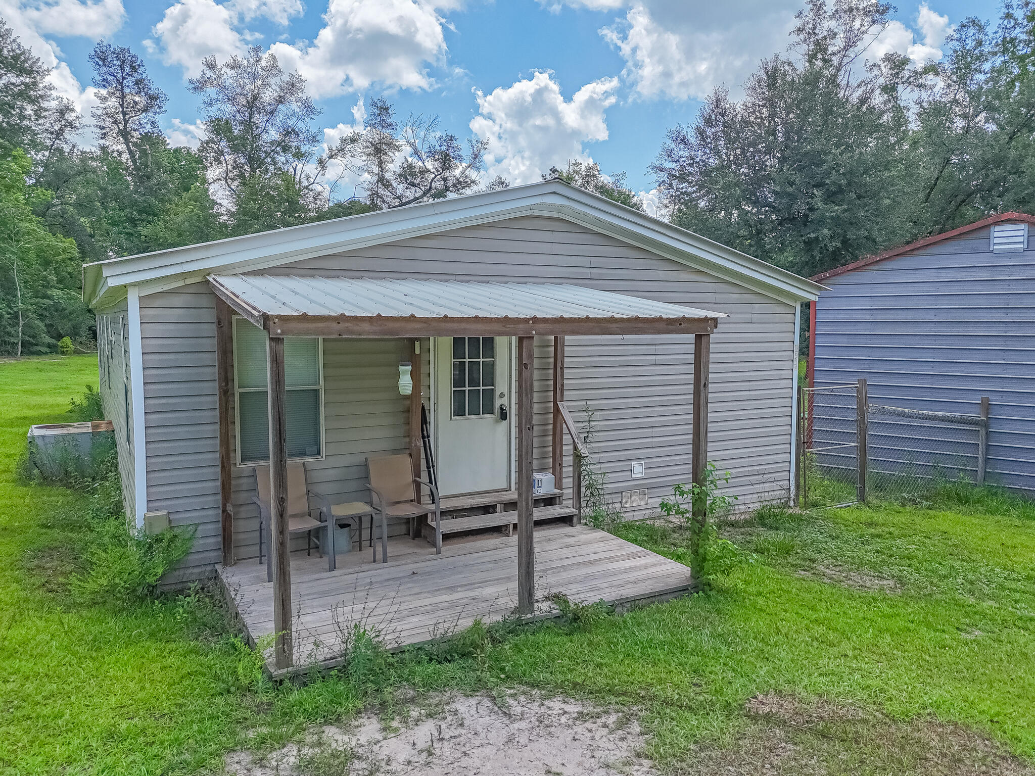Discover the perfect blend of space and functionality at 2214 Mill Road in Cottondale, Florida! Nestled on beautiful 3.77 acres in Flood Zone X, this property offers a peaceful country setting home with two spacious detached garages large enough to hold a several cars, lawn equipment, tractor, etc. There's ample space for additional structures, gardens, horses, or recreational use. Located just minutes from I-10 and the heart of Cottondale, you're within convenient reach of shopping, schools, restaurants and major routes--yet far enough to enjoy privacy and quiet surroundings.No HOA. If measurements deemed important, please verify.