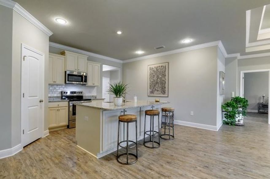 Beautiful, 4 bedroom home with an open floor plan that is perfect for families and entertaining. Just East of Sacred Heart Hospital, this community offers a pool and peaceful living. Light Hardwood flooring throughout, Granite counters, new tile back splash just added and accented by stainless steel appliances. The finish level and style offer a modern coastal feel. New custom barn doors added to the guest suite for a beautiful entryway. The master bedroom has tray ceilings and a large master bath with an over sized walk-in closet. The back porch has been screened in and has a mounted TV for a relaxing outdoor living space overlooking the backyard and conservation area.