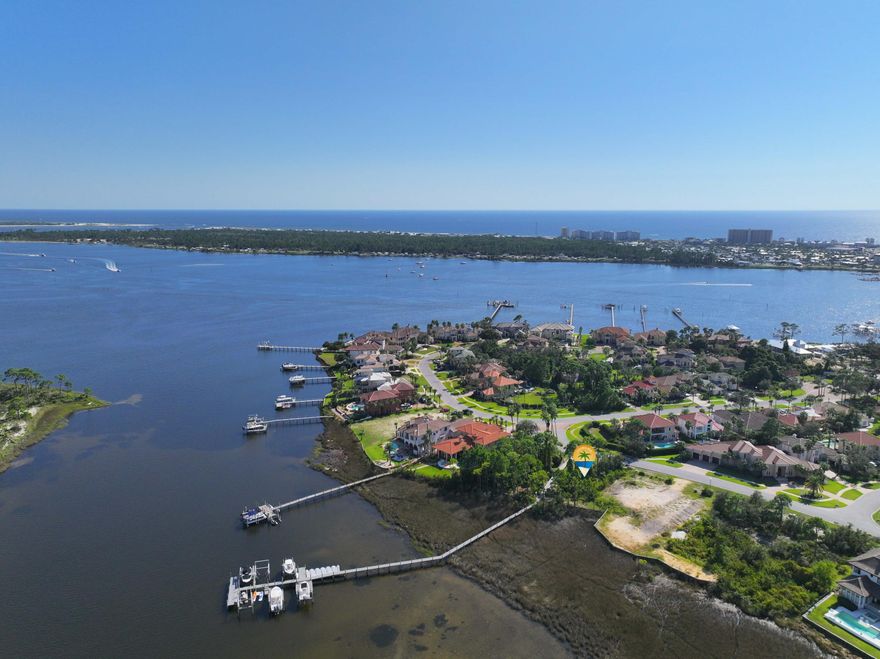 Come and build your dream waterfront home on Grand Lagoon in Panama City Beach! This gorgeous home site is located in Finisterre, a gated waterfront neighborhood with fabulous amenities and perfect location where you can walk to nearby restaurants. Enjoy amenities such as tennis, pickleball, basketball, a playground, and community dock. So close to restaurants, grocery, St Andrews State Park, boating, and of course, the beautiful beaches of Panama City Beach! The adjacent lot is also for sale (see MLS #966125), offering you the opportunity to obtain 2 side by side lots in one of the most prestigious neighborhoods in Bay County. Please check in to any measurements or utilities to confirm information. Call today!