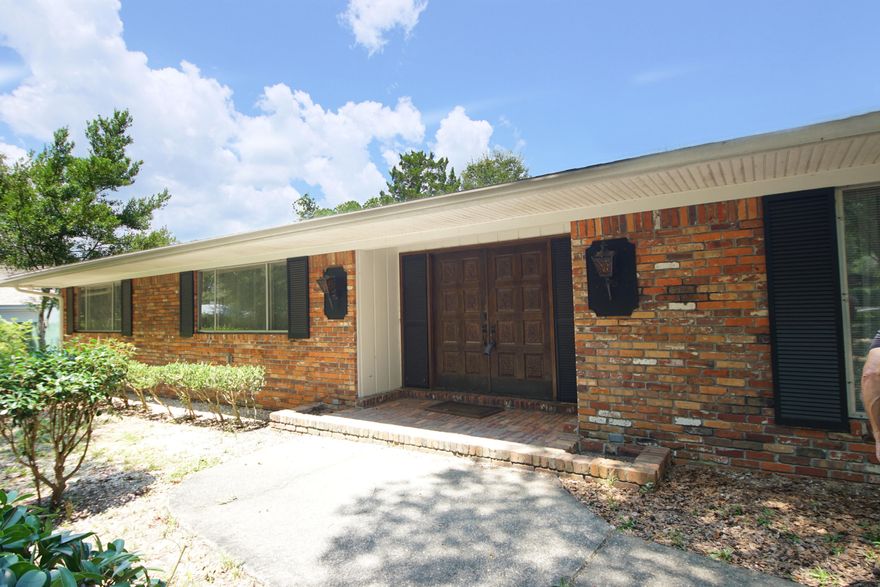 Gorgeous Poquito Bayou home with 4 bedrooms and 2.5 baths with 3275 square feet (2967 sq. ft. plus 308 sq. ft. Florida room). This home sits on a .56 acre wooded corner lot. The home has a newer roof. The home was rewired to copper wiring and replumbed line to the road. Enter this all brick home through the double front doors and notice the nice foyer. The foyer opens to a large family room with vaulted ceilings and fireplace, as well as a second family room. The formal dining room is off the kitchen. The kitchen features a raised bar that seats 3-4 and an eat in kitchen. The laundry room is adjacent to the kitchen and leads into the enclosed garage which can be used as a 4th bedroom. The enclosed garage could be used as a fourth bedroom or a home office. The living room overlooks the Florida room and beautiful back yard. The large, fenced back yard has plenty of space to add a pool. This corner lot has plenty of space for RV, boat or trailer parking! The Poquito Bayou community offers a boat launch ramp and a park, and there are no HOA fees! Neighborhood is close to the air force base, great schools, beautiful beaches, shopping and dining. This home has a large corner lot, is one story and has a very desirable floor plan! Make this house your dream home in the perfect neighborhood! Buyer to verify all information and dimensions.