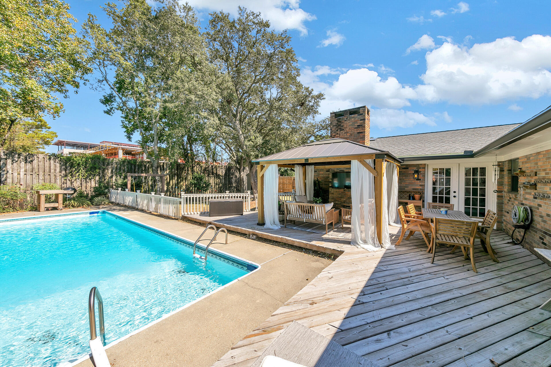Enjoy this simply elegant 2060 square foot, 3 bedroom, 2 bath home located in one of the most desirable neighborhoods in Fort Walton Beach! This home features an 18 x 36 ft pool with large wood deck! The foyer in this home opens to the living room on the left with brand new flooring continuing throughout the home. The foyer also connects to the eat-in kitchen and a large family room with a gas fireplace and vaulted ceilings. The kitchen has been updated, cook dinner on the gas stove while looking out over the backyard and pool! Just off the kitchen is a dining room that features large windows that overlook the pool. Dine with guests while looking at a beautiful backyard! The master bedroom is large enough for a king size bed and additional furniture! There are French doors with built-in blinds that lead to the backyard and pool. The master bathroom features a walk-in shower and closet, and additional shelving for storage. This split floor plan home also features two additional bedrooms off the family room and a full bath. New roof 2021, pool pump, New electrical panel, light fixtures, and garage door/motor. Exterior and other features are: 12' privacy fence, a large backyard with a yard building, and two car garage. This home is only a few blocks from a park and playground, just minutes from the shopping, restaurants, and schools. This neighborhood is one of the highest points in Fort Walton Beach and does not require flood insurance. This great home will not last long!