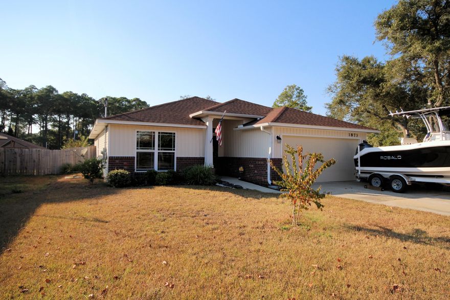 Open House this Friday, Nov 18 1-4pm. Beautiful home only 2 years old located minutes from the Navarre Beach Bridge. Access White Sandy Beaches and Emerald Green water of the nearby Gulf of Mexico only 2 miles away. Navarre boat launch is 1.8 miles away. Convenient to shopping and restaurants, Craftsman style home features Brick Front and vinyl siding for ease of maintenance. Owners have recently added a pergola and fire pit in the privacy fenced back yard- great for entertaining! Open floor plan; kitchen features stainless appliances and a 3-sided granite counter Hop-up Bar open to the dining area. Vaulted ceiling in large 17'X16' Family room. Dining room overlooks rear covered porch. Spacious Master bedroom with double door entry has en suite 13'X14' bath featuring double vanities.
