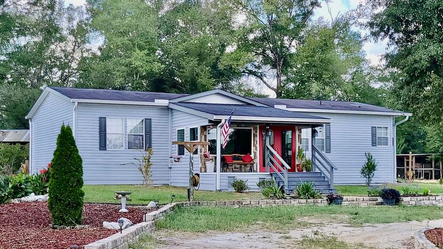 Remodeled home on 10 acres. Front entrance is all window sunroom.  Open concept.  New flooring, completely remodeled kitchen with new custom cabinets, pull outs in all lower cabinets with soft close drawers, butcher block counter tops & new stainless appliances, farm sink w/ Moen faucets. Electric Fireplace with built in cabinets.  Split bedroom floor plan. Tankless gas hot water heater in 2022. Master bedroom has large walk in closet and the bathroom garden tub with a separate shower behind  barn door.  Additional bathroom fully remodeled.  Outside has just been painted.  HVAC installed in 2022.  Concrete footer around entire house. Creek runs along back of the property. Chicken coop, Storage building, Green house, and large workshop with carport, covered back deck. that also has carport attached for equipment.  The back deck has gas hook up for a grill.