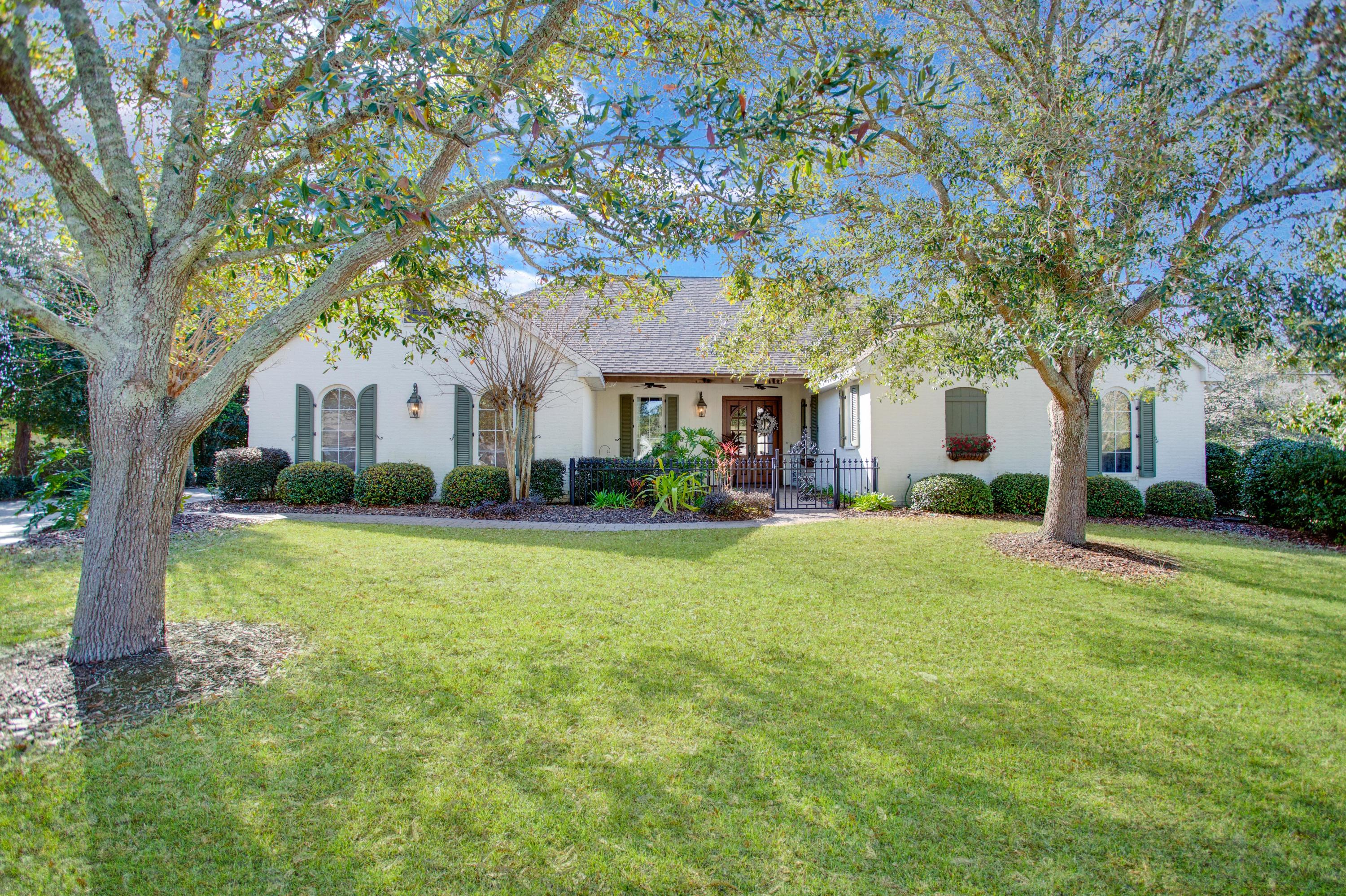 This home is a perfect example of the photos NOT doing a home justice - you really must tour this home to get the true feel. This beautiful custom-built Sandestin home embraces resort style, golf course living. The low-country architecture and Creole-French inspired touches are evident from the moment you first see this home. The lush and mature landscaped front yard welcomes you into a private courtyard with fountain and leads to a set of beautiful double mahogany and glass, arched front doors. As you step inside, you are greeted with a graceful foyer that opens into a large great room with a wall of windows overlooking the pool and golf course. Just off the great room you will find a richly appointed office/library accessed by a set of French doors. This room has a double closet that