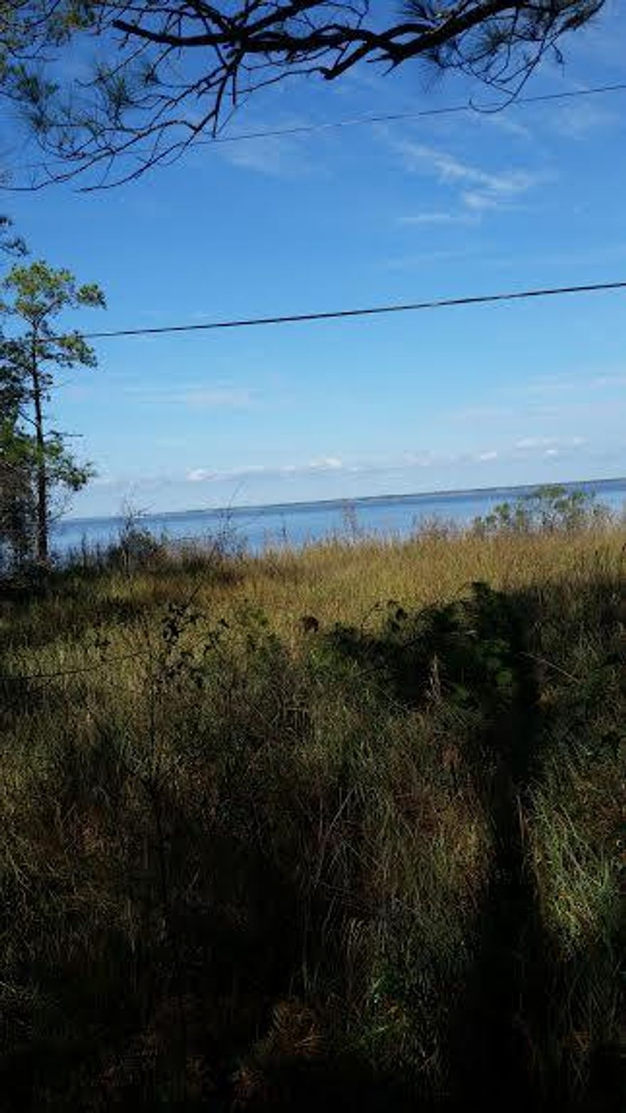 Great building lot with excellent water views to the Bay. Within a few feet of the bay access for your kayak and paddle board. House plans partially completed. This lot is the best priced lot on the paved road with a great water view.