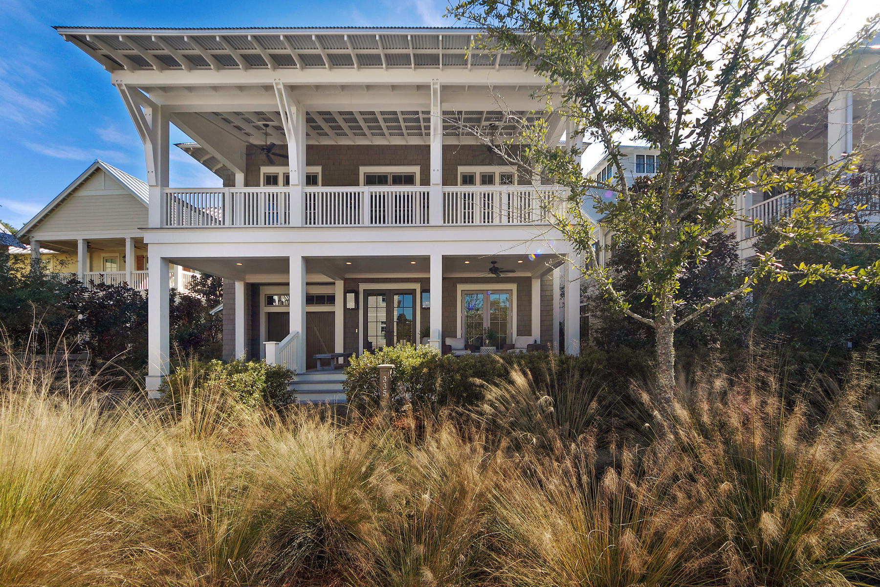 This exquisite home located in the desirable phase 3 of Watercolor offers amenities the discriminating buyer seeks. From the moment you enter the quality of construction and the attention to all the details of this beautifully customized beach home become evident ten and twelve foot coffered, stained-pine ceilings, all wood-paneled walls, reclaimed eight inch heart of pine floors, Calcutta marble counter tops, commercial grade appliances, and four porches made of Ipe decking.You will enter the home through custom mahogany French doors into a long wide hallway which stretches to the back porch. The two guest suites, each with a full bathroom, open to a quiet porch that overlooks the beautiful back yard and fire pit, and a community common preserve of native NW Florida fauna.