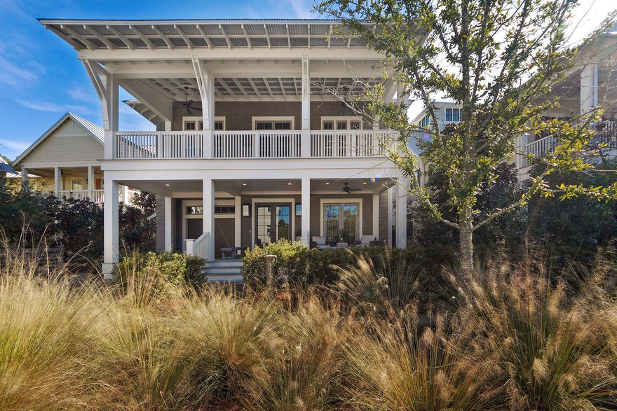This exquisite home located in the desirable phase 3 of Watercolor offers amenities the discriminating buyer seeks. From the moment you enter the quality of construction and the attention to all the details of this beautifully customized beach home become evident ten and twelve foot coffered, stained-pine ceilings, all wood-paneled walls, reclaimed eight inch heart of pine floors, Calcutta marble counter tops, commercial grade appliances, and four porches made of Ipe decking.You will enter the home through custom mahogany French doors into a long wide hallway which stretches to the back porch. The two guest suites, each with a full bathroom, open to a quiet porch that overlooks the beautiful back yard and fire pit, and a community common preserve of native NW Florida fauna.