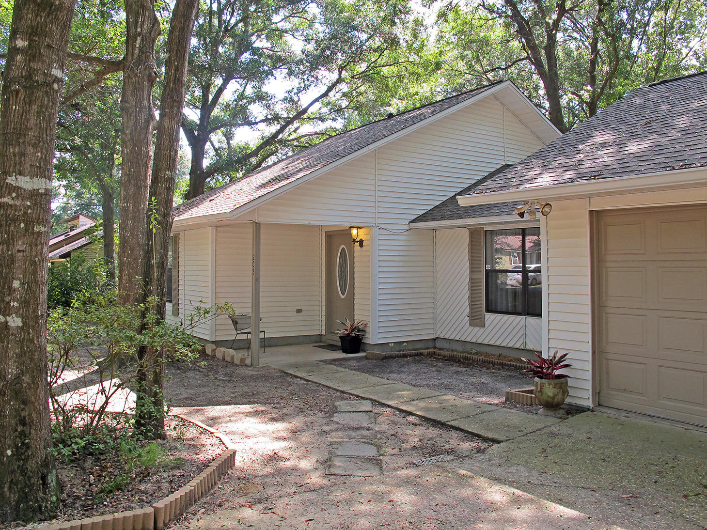 Charming must-see country cottage, move-in ready with upgrades galore! The open floor plan invites you in, the living room, kitchen and dining area flowing one into the next and sharing beautiful 16'' tile flooring. New roof in 2017, new deck outside the master bedroom, new back doors, new carpet, fresh paint on textured walls and upgraded baths. Wood-burning brick and tile fireplace is freshly re-grouted, and 30-foot back deck reinforced. The two decks look out over the huge sun-dappled backyard, shaded by mature trees.This comfy home lives larger than its 1279 square feet. Between the open living space, the 30-foot deck and the third-acre lot, there is more than enough room to throw a spectacular housewarming party! (continued)