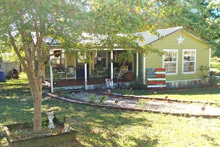 WATERFRONT -- BRING YOUR FISHING RODS!
This adorable cottage was one of the early fish camps on 620 acre Juniper Lake. You'll flip over the character and charm of this 2 BR, 1 Bath home. Completely updated with new plumbing and wiring in 2002, the house is styled with a vintage kitchen and exposed rafters in the living room. The property features a 10x24' barn with loft storage, a 16' deck to overlook the fabulous lake views, a double carport, and a relaxing covered front porch. The house has a metal roof and cement-board siding, a cozy propane fireplace in the parlor, a sunny dining room, and central heat & air. Property has 70' of waterfront. Fish from your dock, or there's easy access by boat to the main body of Lake Juniper which is full of brim, crappie, and large mouth bass!