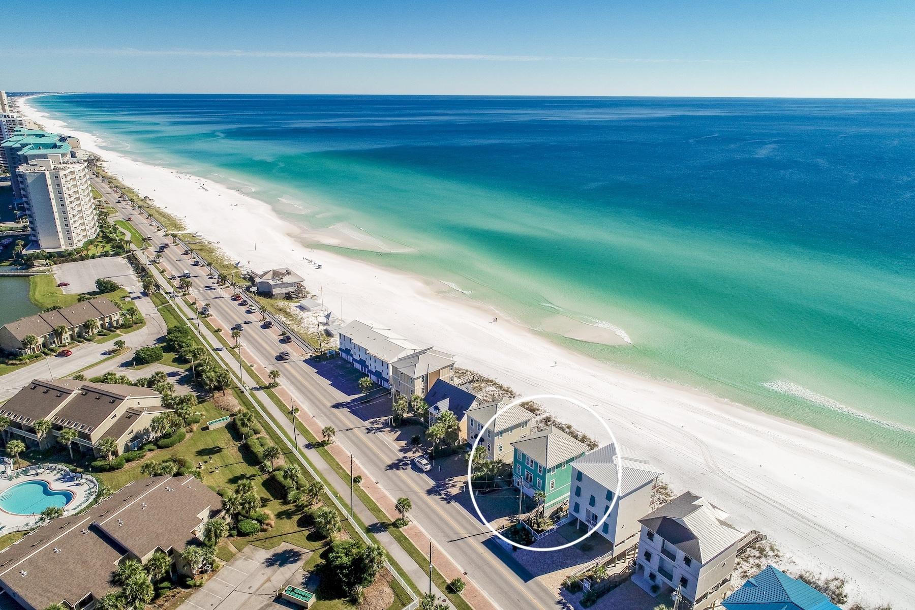 Experience unparalleled gulf front vistas from this prominently located beach front retreat primely positioned on 50' of premium linear gulf frontage highlighted by three stories of coveted south facing deck space. This exemplary five bedroom rental machine has been recently updated and well designed for optimal income potential offering $175,000-$200,000 projected gross annual income. Notable features include ample exterior parking as well as a spacious two car garage with additional storage for beach equipment. The open floorplan is an immediate highlight with a functional set up allowing for two spacious gulf front bedrooms on the first level sharing a jack-and-jill bathroom and allowing immediate access to the rear decks & subsequent path to the beach. The awe-spiring kitchen and