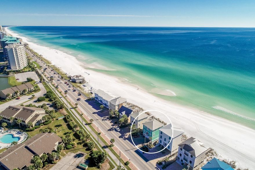Experience unparalleled gulf front vistas from this prominently located beach front retreat primely positioned on 50' of premium linear gulf frontage highlighted by three stories of coveted south facing deck space. This exemplary five bedroom rental machine has been recently updated and well designed for optimal income potential offering $175,000-$200,000 projected gross annual income. Notable features include ample exterior parking as well as a spacious two car garage with additional storage for beach equipment. The open floorplan is an immediate highlight with a functional set up allowing for two spacious gulf front bedrooms on the first level sharing a jack-and-jill bathroom and allowing immediate access to the rear decks & subsequent path to the beach. The awe-spiring kitchen and