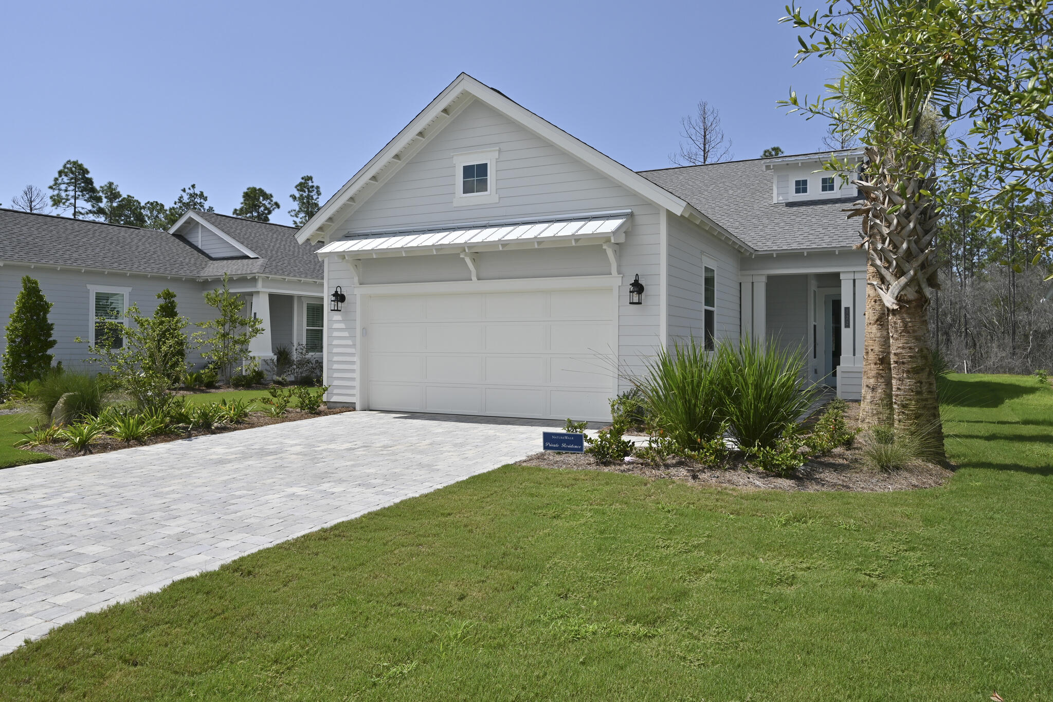 This like new, fully furnished home in Naturewalk at Watersound Origins is move-in ready! The single-story 2-bed, 2-bath floor plan boasts a convenient den and an oversized 2-car garage. Interior features include laminate flooring throughout with tile in the laundry and baths, granite countertops, and more. The gas fireplace in the open concept living area is a natural gathering place, and the spacious covered back porch lends itself to al fresco dining & entertaining. The primary bedroom boasts two walk-in closets plus a luxurious ensuite bath with dual vanities and a tiled walk-in shower. Residents enjoy access to world-class amenities, including a resort style community pool, fitness center, world-renowned par-3 golf course, sports courts, nature trails, and dock access at Lake Powell