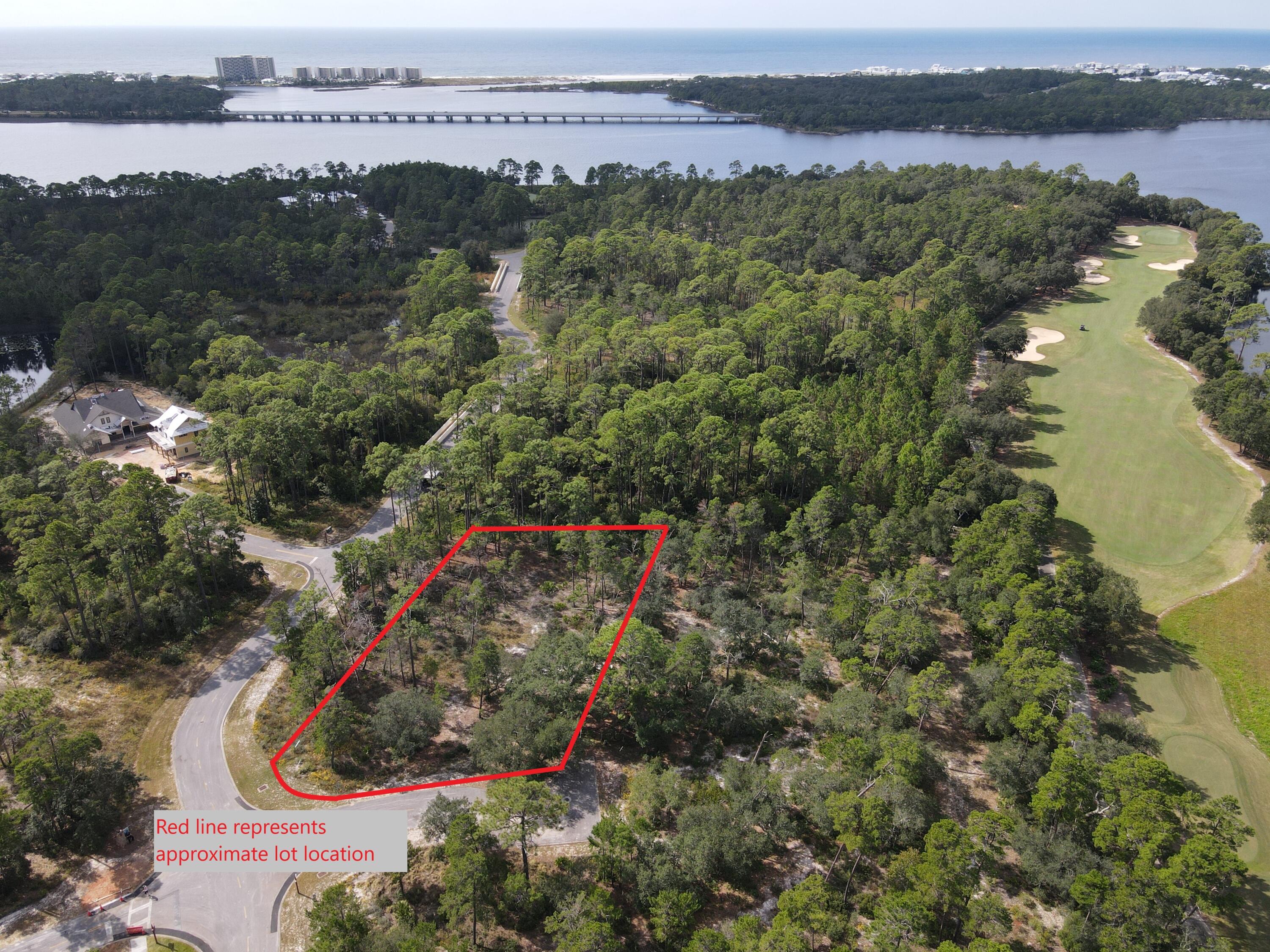 An almost 2/3 acre lot in a gated golf course community minutes from the Emerald Coast beach, with plenty of room to build your new custom home and pool. This premier ''A'' tier lot backs onto conservation area, and one side borders undeveloped common area. Only .4 miles to the clubhouse of Sharkstooth Golf course, designed by Greg Norman. WIld Heron is surrounded by the largest dune lake in North America. Some of the amenities in the neighborhood include the fully equipped fitness center, boat house with kayaks, event lawn, fire pit , heated pool with hot tub, hiking trails and playground. Pier Park is a short drive for shopping and dining. Tennis, Golf and Beach memberships available for an additional fee. One of the lowest $/acre lots >.5 acres available in Wild Heron.