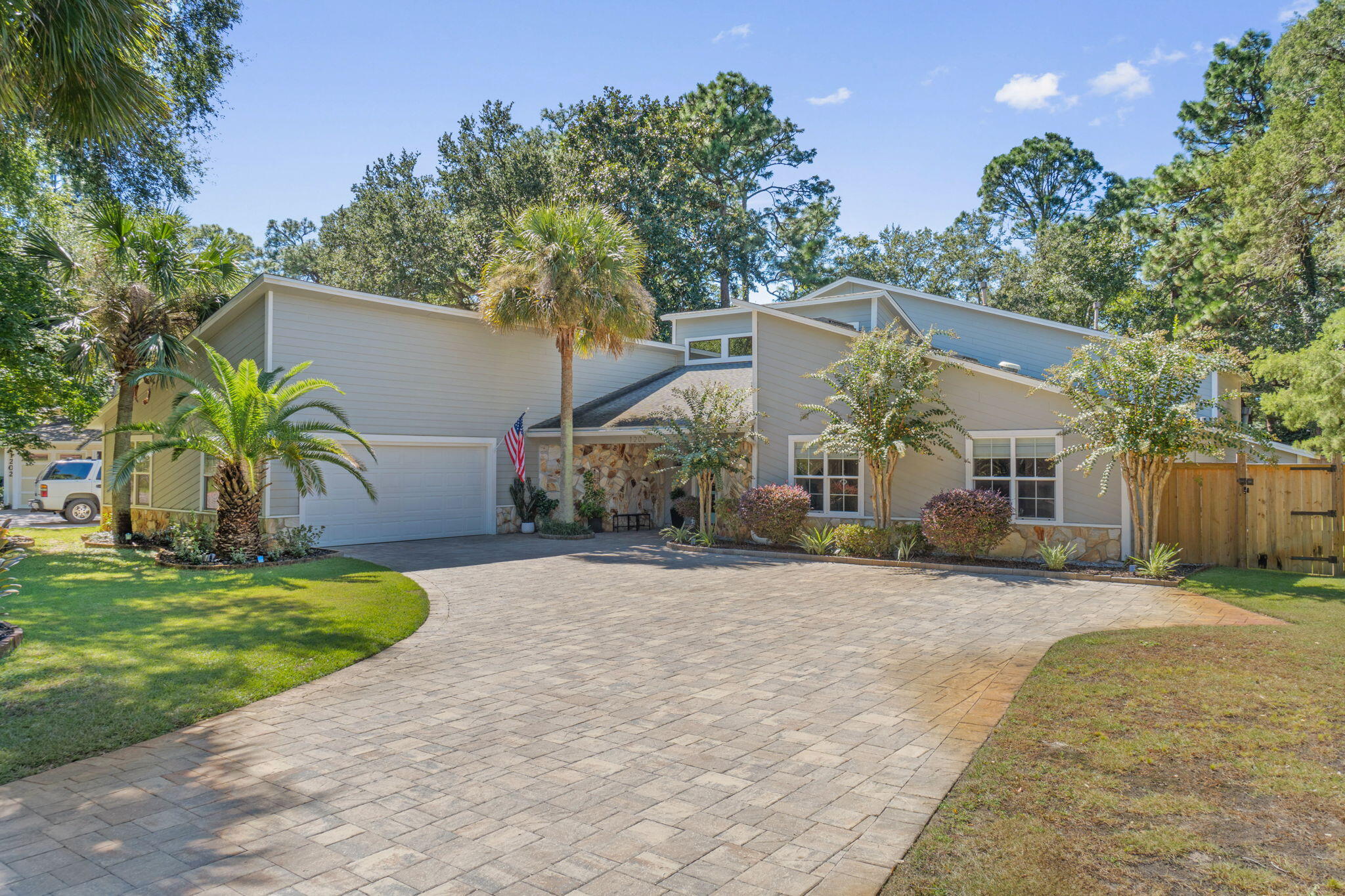 Welcome to this stunning, renovated 5-bedroom, 4 bathroom home located in an exclusive gated beach community. As you step inside you'll be greeted by the elegance of cathedral ceilings and new engineered hardwood floors that flow throughout the home. This residence offers two luxurious master suites, ideal for added privacy or multi-generational living. The primary master suite is an expansive retreat, complete with a large sitting area, a huge walk-in closet, and direct access to your very own backyard oasis. Step outside to enjoy the private in-ground pool featuring a new pool pump. You will be surrounded by fresh landscaping and a new 8 foot tall privacy fence, perfect for relaxation and entertaining. The kitchen is a chef's dream with an island and brand new appliances. Additional upgrades include new Roman shades, a new gas water heater and a new HVAC, ensuring both comfort and efficiency. With its luxurious amenities and proximity to the private beach, this home offers the perfect blend of style and coastal living. Don't miss your chance to own this piece of paradise!