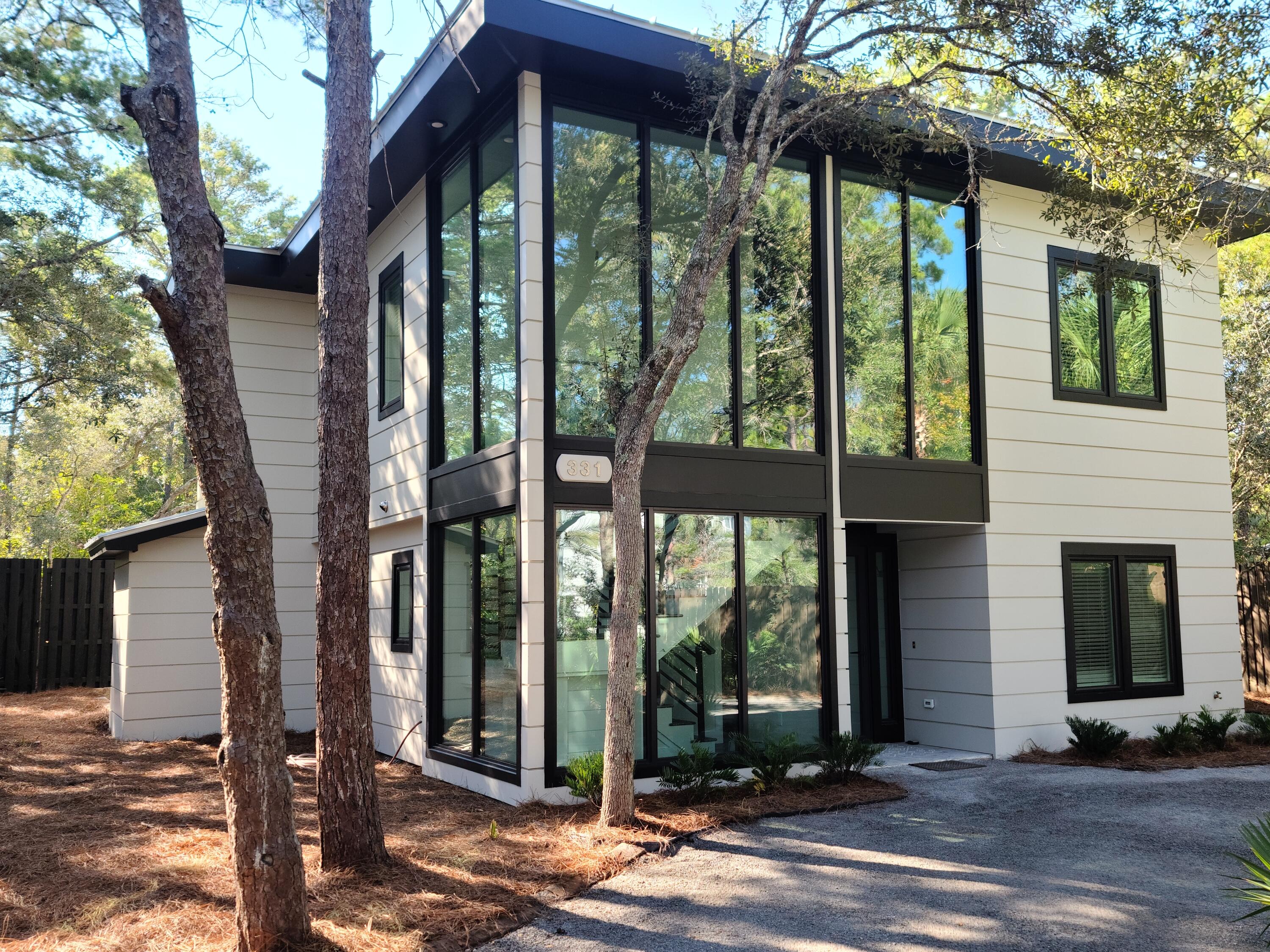 Experience new, contemporary construction on one of the most pristine, private lots in Old Seagrove. From the street, this home makes a modern statement--two stories of expansive glass sheets rise, creating unobstructed views of natural wonders as light floods the entryway. This custom-plan provides wonderful interior living with two master suites--each with a beautiful master bath. Both floors offer full living areas. The downstairs living walks out to a backyard sanctuary, with a heated, saline pool & spa as well as a covered patio with gas hearth. Impeccably manicured, the outdoor landscape provides maximal privacy. The home is set back off Canal Street while also embracing a sizeable backyard den for poolside relaxation. One of the sellers is a FL. Lic. Real Estate Agent