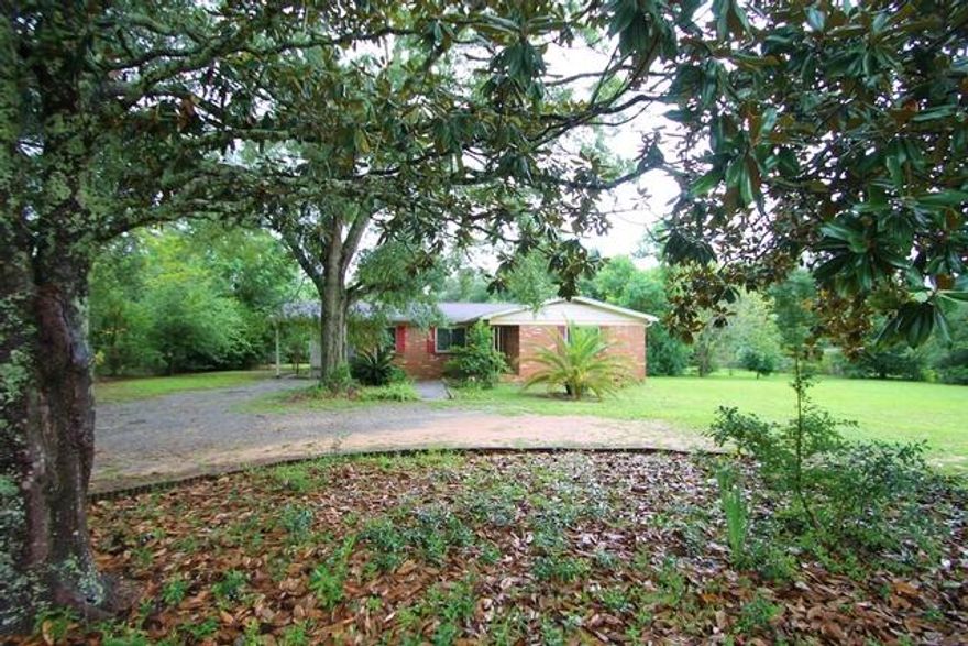 Great all brick home on a large lot and located in a very nice neighborhood.  3 bedrooms and two baths. Not often do you see a home with the ORIGINAL HARDWOOD FLOORS in such good condition and so lovely.  No carpet! Just these wonderful floors throughout! See photos!! Kitchen has all appliances and nice tile accents. Large dining area. Master bedroom has a walk in closet. There is a laundry porch just outside the kitchen door.  The lot is very large (over two thirds of an acre) and is completely fenced and has a nice yard shed. Absolutely GORGEOUS mature oaks in the front yard.  Built in 1971 and they don't build them like that any more!! Roof was replaced in 2013 so still in very good shape! Great property!!!