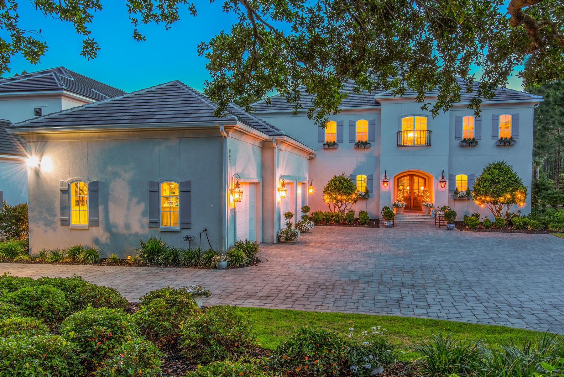 Stately custom home incorporates elegant interiors in a warm open concept floor plan in Regatta Bay. A convenient, very private first-floor mother-in-law suite with kitchen and separate entry is a welcome addition to this well-designed floorplan. High ceilings and superb detailing enhance light-filled interiors. Living spaces are classy and comfortable with first-floor concrete floors and modern brass light fixtures reminiscent of New England design. The cook's kitchen is meant for gathering and entertaining. High end appliances, including a Thermador double oven gas range, wine cooler, and ice maker compliment the impressive design. A large island provides extra work space, cabinets, and a bar. The custom white cabinets and Cambrian countertops complete the modern space. The kitchen opens to the beautiful large dining area overlooking the outdoor living area and pool, as well as the large family room, with space for a grand piano. The gracious first-floor master suite is sumptuously appointed with a dressing suite of custom walk in closets, one very large, and a sitting area. A richly appointed master bath includes dual vanities, an over sized multi-jetted shower, and a garden tub. The large laundry room accommodates an extra refrigerator, cabinets, and a computer work space. The mud room is a welcoming space that leads to the three car garage. The grand stairway in the foyer has custom metal balusters and opens to the second floor with a window seat and a beautiful large lantern. Upstairs you'll find an over sized hallway, with room for a sitting area, an office, three large guest bedrooms with ensuite baths and walk in closets, an office and a large game room/bunk room with eight full-sized custom built-in bunk beds. The game room has space for a pool table as well as seating for the large TV area. Two of the bedrooms open up to a wonderful balcony overlooking the golf course, providing the perfect spot for a morning cup of coffee. There are two crib closets in the bedrooms that will allow a full sized crib and baby to be near parents but not share a room. A wonderful large walk-in attic space allows you easy access to stored items.
Grounds include blooming petunias, roses, hydrangeas and mature landscaping for privacy. Entertaining continues outdoors under the large covered back patio, complete with comfortable sofas and a TV. Cool off in the heat and be refreshed with the beautiful pool and spa. A fire pit and dining area complete the space. Built by Old South Homes, no details were overlooked.
The Regatta Bay lifestyle offers access to a beautiful golf course, a golf club for dining, two tennis courts, a community pool and playground. You can take a golf cart to the beach, Destin Commons, Whole Foods, LuLu's and the marina, where you can store your boat. Make this one-of-a-kind home yours.