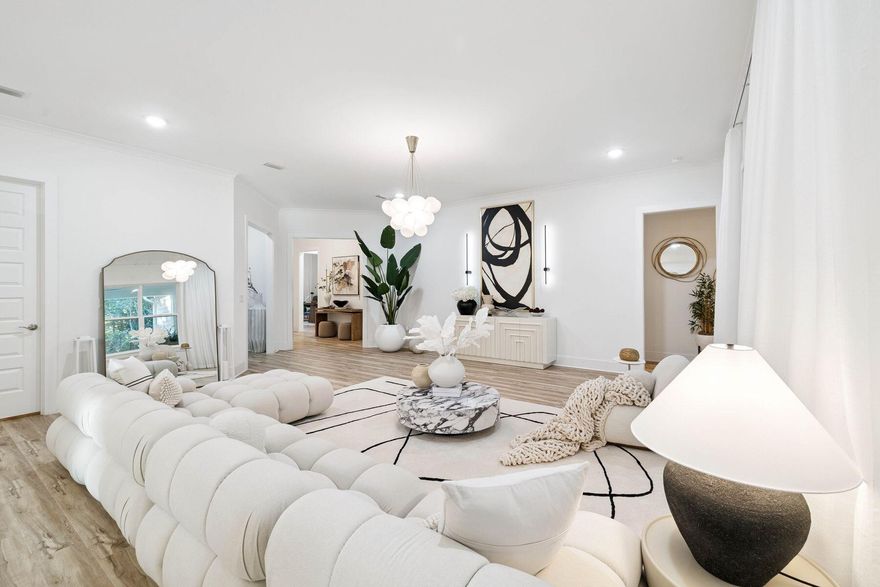 Built in 2024, this picture-perfect home is a gem. Nestled among mature trees and backing up to green space, it enjoys a serene, private location. The front yard has a broad driveway approaching a three-car garage and a shady covered porch. Showcasing a host of upgrades, this delightful Florida cottage is laid out all on one level with dormer windows in the roof providing added appeal. The spacious open living room has ample space for family life and entertaining, yet each designated area retains a cozy feel. The outstanding chef's kitchen is the hub of the home with premium maple bisque cabinetry and cool quartz countertops, providing a practical space to inspire any cook. A range of KitchenAid appliances and a mosaic tile backsplash add a touch of interest. The high-tech refrigerator, upgraded oven and microwave ensure it is as functional as it is beautiful. The well-positioned island makes it easy to create and serve meals while still being part of the conversation. Throughout this home, premium finishes combine designer touches with home comforts to create an enviable place to relax. Fully upgraded maple LVP flooring extends from the living room to all four bedrooms and their respective fitted closets. The dining area is crowned with a statement chandelier, while pendant lighting features above the kitchen island. As an added touch of class, a Midas touch of gold elevates the faucets in both the kitchen and the master bath. Four light, bright bedrooms and three bathrooms show as new with luxury fixtures extending to backlit LED mirrors in the bathrooms. Frameless glass shower doors, sleek floating vanities and a garden tub make every bathroom look like a lush ensuite. To ensure a good night's sleep, the home includes motorized blackout shades in the main room, and drapes and blackout curtains elsewhere. Storage is more than generous. Every bedroom and hallway includes closets, complemented by an additional laundry room closet. The generous garage is currently laid out with a custom closet and a workout area complete with gym flooring. There's still plenty of space for vehicles, bicycles and a golf cart. Step outdoors onto the furnished patio and enjoy the sounds of nature in the private green space. Kids have ample freedom to roam and play safely in this gated family-friendly community in the heart of Freeport. Those looking for a newer home on a tranquil lot will find all the hard work has already been done at this pristine residence, which is fully upgraded and move-in ready.