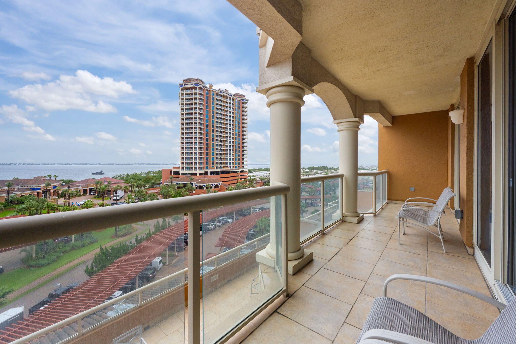 Welcome to luxury coastal living at Portofino Island Resort! Rental projections coming in at $79,000+! This spacious 2-bedroom, 2.5-bathroom condo offers the perfect blend of comfort and elegance in one of Pensacola Beach's most sought-after communities. Step inside and enjoy stunning views from the moment you walk in. Located in the heart of the resort, this spacious unit features an open floor plan with tile flooring and neutral paint throughout, creating a clean and inviting atmosphere. The full kitchen is well-equipped with ample cabinet space and a panel-ready refrigerator, all opening to a generous dining area and breakfast bar. The living area is bright and airy, with large glass doors displaying views and leading to a 27-foot-long balcony where you'll enjoy overlooking the San ta Rosa Sound and the resort's tropical landscape. Both bedrooms are private retreats with en suite bathrooms and direct access to the balcony. The primary suite boasts multiple closets and a luxurious bathroom with all you could want! It boasts double vanities, a jetted whirlpool tub, a walk-in tile shower, and a separate water closet. The second bedroom, located on the opposite side of the condo, also includes its own full bathroom for added privacy. Portofino Island Resort offers unparalleled amenities including direct access to both the Gulf of Mexico and the Santa Rosa Sound, multiple pools and spas, a full-service spa, a state-of-the-art fitness center, tennis courts, and on-site dining. Only minutes from the dog park and all that Pensacola Beach has to offer, this condo will make you feel at home and on vacation all year long!