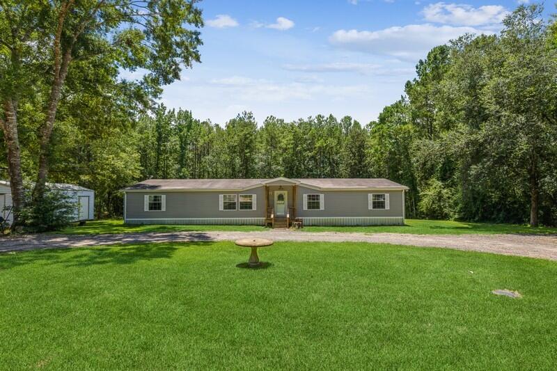 Beautiful double-wide mobile home on almost an acre lot with small creek in the back of the property. This home has 3 bedrooms with 2 being masters with their own bathrooms. Both connecting bathrooms have TONS of storage! Both the master bedrooms have double closets. There is a living room as well as a family room for all your large gatherings. The kitchen has loads of cabinets and one of the nicest refrigerators on the market. The covered back porch looks down on the backyard where a small creek runs through. The property goes past the creek for endless possibilities. The home even comes with a large metal shed, perfect for your lawn tools and toys. Schedule your showing today.