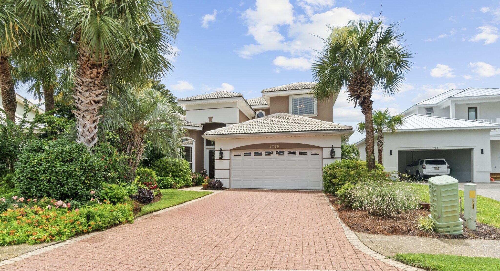 Step into the latest gem within the exclusive community of Destiny East. This custom-built home features 4 bedrooms and 2.5 bathrooms, situated on one of the largest lots on the street. A private oasis garden adorned with tropical plants and flowers surrounds the newly resurfaced solar-heated pool. The residence boasts a whole-home Generac generator, new pool equipment, central vac, hurricane shutters, and a spacious open floor plan designed for modern living.The gourmet kitchen is equipped with top-of-the-line appliances, seamlessly flowing into a spacious living area perfect for entertaining. The primary suite offers a serene retreat with a spa-like bathroom and a generous walk-in closet.