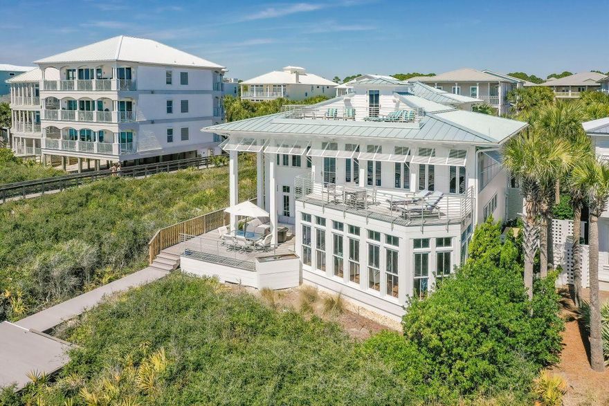 Offering an ideal location in Seagrove Beach, this gulf-front home features an expansive floor plan and panoramic water views. A true coastal retreat, this home has been well maintained and has been refreshed with white paint both inside and out. A private courtyard leads to the entrance, which then opens to reveal light, bright, and open main living areas that boast incredible views of the Gulf of Mexico. Prepare meals in a chef's kitchen with a beautiful coffered ceiling, two pantries, high-end appliances, double ovens, and a large island with room to seat eight. Perfect for entertaining, the home features a fully-equipped wet bar and large area for formal dining while French doors lead out to a spacious deck that overlooks emerald green waters.