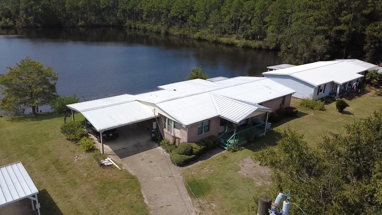 This LAKEFRONT home offers breathtaking views and a spacious interior! Perfectly maintained by the original owners for 40 years, this home is ready for its new story! When you pull up, you're welcomed by an abundance of parking, a large lot, and the beautiful sparkling water of the lake out back. Stepping up to the front door, take note of the large, covered porch. Heading inside you are welcomed by the dining area, kitchen, and living room - all offering breathtaking lake views. The master bedroom is huge with an en suite bathroom and walk in closet, and the additional bedrooms share a bathroom in the hallway. The foyer offers the perfect secondary living space by the front door. The crown jewel of this house is its sunroom offering the perfect space for relaxing with a coffee or tea overlooking the lake. You do not want to miss this home, stop on by and make your waterfront dreams come true!