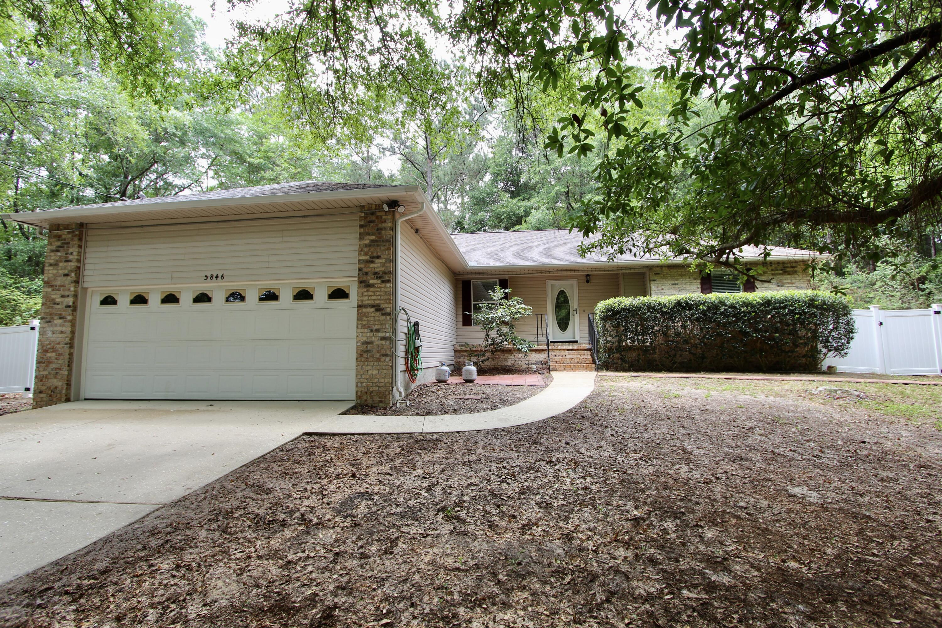 Situated on a tranquil 1-acre lot in Crestview, this inviting 3-bedroom, 2-bathroom residence offers a harmonious blend of comfort and functionality. The home features a partially privacy-fenced backyard with gates, complemented by an additional smaller fenced section--ideal for pets, gardening, or creating a private retreat. A bonus storage area provides ample space for your needs, while the hot tub offers a relaxing escape. Additional highlights include an air-conditioned shed, perfect for a workshop or studio, and an extra utility shed offering ample storage space for tools, equipment, or seasonal items. The garage is pre-wired for an electric vehicle (EV) charging station. Brand new water heater. AC 2018. Roof 2021