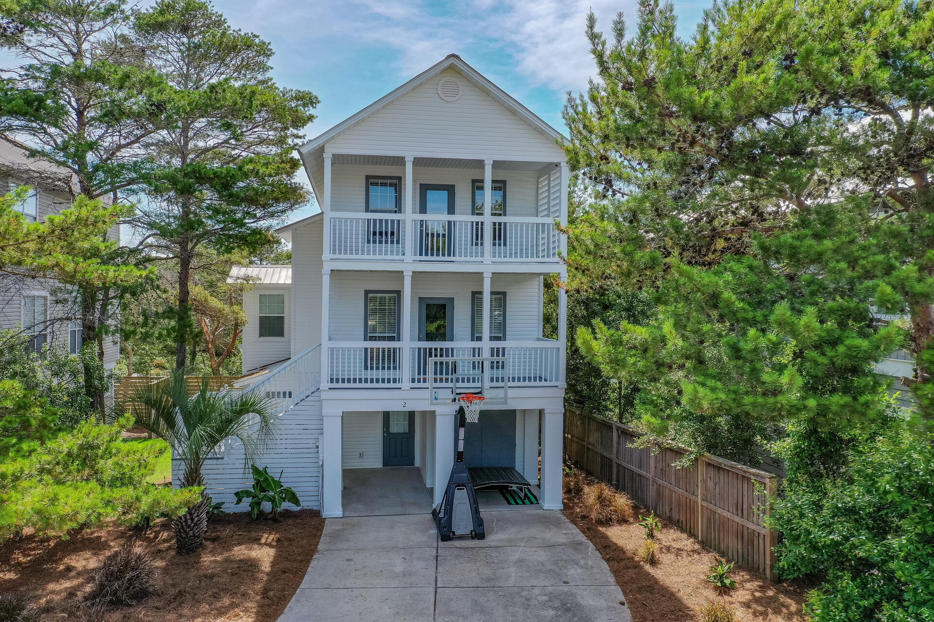 Classic Florida Style beach home with 4 bedrooms and 3 full baths. Great for a full time residence or vacation rental property. Marlin Street is located in the Blue Mountain Beach area in the quiet Blue Gulf neighborhood. Beach access is a 5 minute bike ride and less than 1200 yards to the East. The Blue Mountain Creamery and Blue Mabel restaurant are just two nearby favorites for locals. Large open floor plan on the main level includes a den, dining area, and updated kitchen. Kitchen features granite, stainless appliances, and new cabinetry. Updated luxury vinyl plank flooring throughout the home will make maintenance and cleaning a breeze. The top floor has two bedrooms. The main bedroom easily holds a King, has a deep walk in closet, and opens onto the shaded front porch.