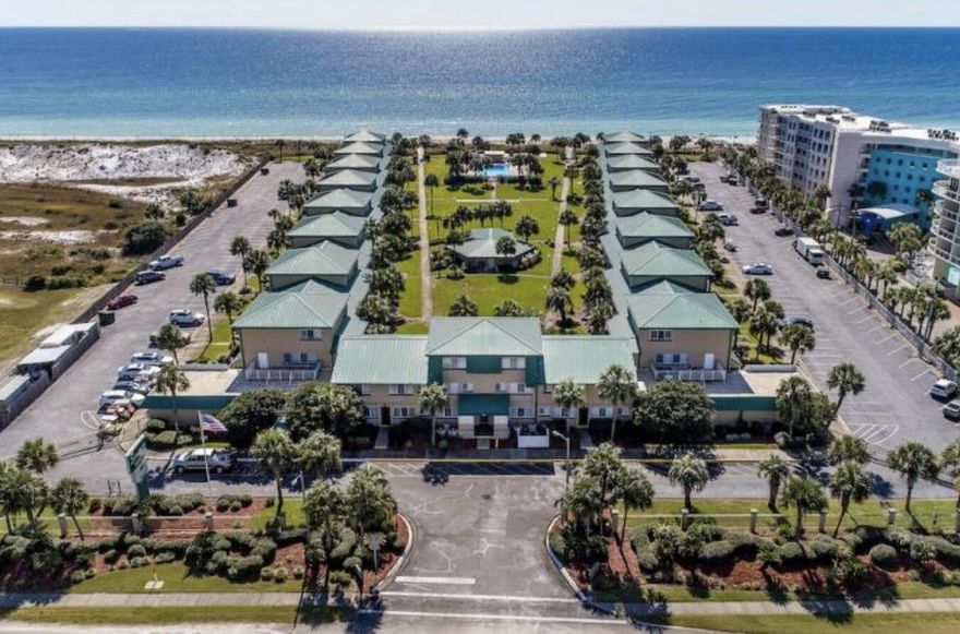 Nestled along the sun-kissed shoreline, this oceanfront one-bedroom condo offers a serene coastal retreat. The private entrance opens into a bright, airy living space with floor-to-ceiling windows! The  interior features an open-plan living area with a compact, fully equipped kitchen with dining space for six! Upstairs you will find cozy bedroom with two plush queen beds, bathroom and two owner closest in hall area.  Step outside to a private patio surrounded by lush green space, perfect for morning coffee or evening sunsets. Parking is conveniently located just out front. The community's sparkling swimming pool, framed by swaying palms, invites relaxation just steps from the beach! NEW AC Condensing Unit May 2025, Hot Water Heater November 2024!!!