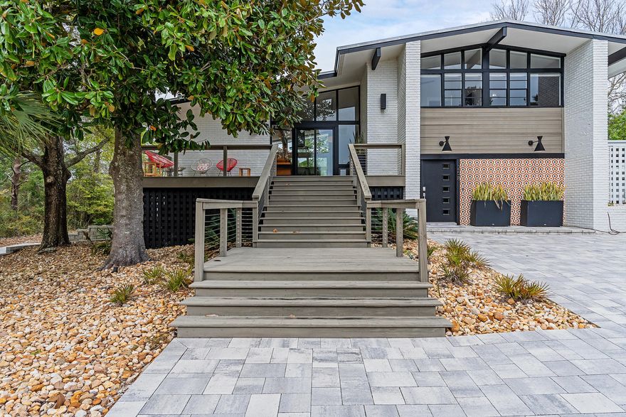 'Florida Flashback' - Built in textbook midcentury modern style in 1960, both the interior and exterior have undergone a complete transformation to embrace the original architecture with new-age design elements. Windows stretch from floor to ceiling keeping the home doused in Florida sunlight while the drool-worthy renovation boasts clean lines and pops of contemporary coastal decor. Both stylish and welcoming, the redesign of this home is flawless in execution. Encompassing 2,375 square feet, this home has five bedrooms, three and a half baths, over a half acre lot, private heated pool, over-sized one car garage, fully fenced in yard, and an Airstream as poolside decor for the ultimate retro-feel. Located in Dune Allen minutes from public beach access and the Santa Rosa Golf Club. NO HOA