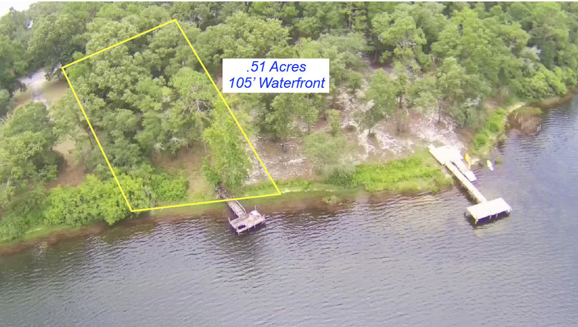 Peaceful, wooded .51 acre lot w/ 105' of waterfront on beautiful Kings Lake in Defuniak Springs.