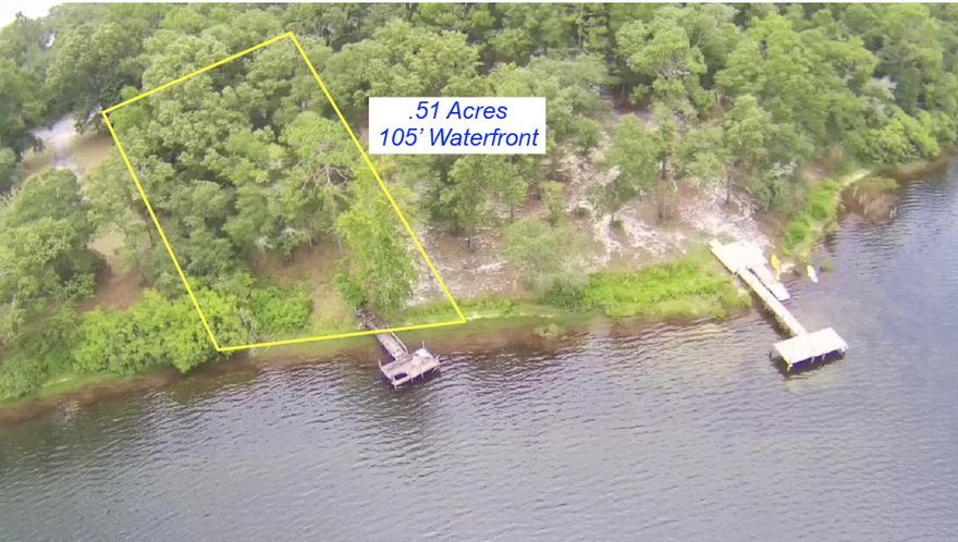 Peaceful, wooded .51 acre lot w/ 105' of waterfront on beautiful Kings Lake in Defuniak Springs.