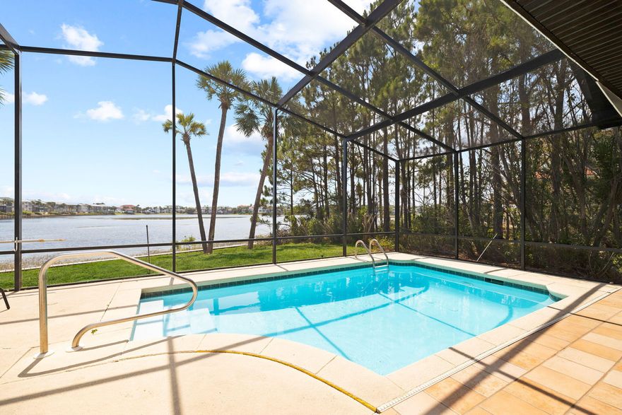 Presiding over 45 feet of lake frontage on Four Prong Lake in Destiny East, this rare single-story home has been extensively renovated and shows like new. Fresh paint, updated lighting fixtures, shiplap accents and porcelain tile flooring combine to create a pleasing ensemble of living spaces. However, it's the panoramic views of the lake and palm-lined shore that really capture the attention, especially at sunset. Jump in the screened pool for a morning dip or chill out in the soaking tub after a mammoth shopping spree and enjoy these priceless waterfront vistas. The outdoor living area is arranged poolside with generously covered and open sitting areas for dining and relaxing. The spacious kitchen is well-appointed with a built-in oven, French-door refrigerator and farmhouse sink. Gleaming white cabinets contrast with wood-tile flooring and stainless steel appliances. The adjoining dining area has lighted cabinets for displaying treasures. Sink down on the corner sofa in front of the fireplace and enjoy the serene pool and lake views through the sliding doors. The master bedroom boasts a lavish ensuite bathroom with a walk-in shower, double vanities and a deep soaking tub. It has direct access to the pool and patio for an early morning stroll enjoying lake and bird life. Two further guest bedrooms include an ensuite and a family bathroom. The bonus room can also be used as guest accommodation or as a game/ media room. All three bathrooms have been fully updated with granite countertops, new cabinets and showers. Destiny East remains one of the most prestigious gated communities in the area. There are amenities for all ages with a lagoon-shaped pool, lighted tennis courts, pickleball and basketball courts, a putting green, a children's playground and a well-equipped fitness center. Just minutes away are beachfront restaurants, fishing charters, sugar-white sand and emerald gulf waters.