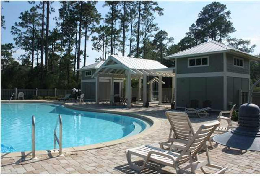 Large lot in lovely Grayton Bayou S/D, providing brick paver roads, Florida cottage style homes, and sparkling pool equipped with restrooms. Common area with pond, picnic area, bayfront park, and boat launch not far away. Buyer should confirm lot dimensions as they are estimated