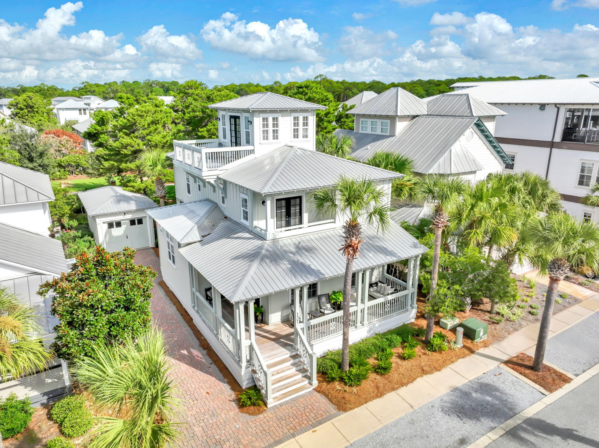 This beautifully furnished custom home by Randy Ledman sits on a large lot ideally located in the heart of Seacrest Beach. Just a short distance from the community beach access and the resort-style lagoon pool, the property also backs up to a peaceful open green space, offering both privacy and relaxation. Inside, the home showcases cherry hardwood floors throughout, extensive wainscoting and trim, and an architecturally designed open-concept floor plan ideal for entertaining. Updated lighting complements the abundant natural light that fills the home, creating a warm and cheerful ambiance. The kitchen features an impressive 11.5-foot coffered ceiling, while the first floor offers 10-foot ceilings and the upper levels 9-foot ceilings. Two spacious primary suites provide comfort and flexibility, and multiple owner's closets and walk-in storage areas ensure plenty of space for belongings. Outdoor living is a highlight, with a large wraparound front porch, a private screened back porch, balcony access from the upstairs bedrooms, a master bedroom balcony, and a third-floor porch/sundeck with scenic views. Additional features include an outdoor shower, detached garage, and a large brick-paved driveway offering both convenience and coastal charm. The HVAC system and third-floor deck were replaced in 2021. The Seacrest Beach tram service operates eight months of the year, and this home is perfectly situated between tram stops D-2 and D-3 (see map in documents). The furniture exclusion list is in documents.