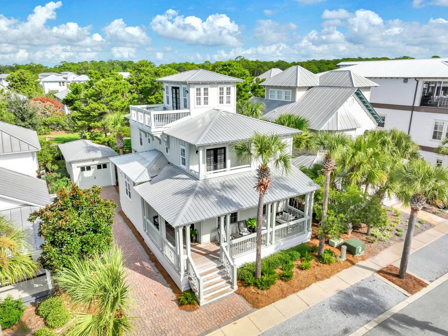 This beautifully furnished custom home by Randy Ledman sits on a large lot ideally located in the heart of Seacrest Beach. Just a short distance from the community beach access and the resort-style lagoon pool, the property also backs up to a peaceful open green space, offering both privacy and relaxation.  Inside, the home showcases cherry hardwood floors throughout, extensive wainscoting and trim, and an architecturally designed open-concept floor plan ideal for entertaining. Updated lighting complements the abundant natural light that fills the home, creating a warm and cheerful ambiance. The kitchen features an impressive 11.5-foot coffered ceiling, while the first floor offers 10-foot ceilings and the upper levels 9-foot ceilings. Two spacious primary suites provide comfort and flexibility, and multiple owner's closets and walk-in storage areas ensure plenty of space for belongings. Outdoor living is a highlight, with a large wraparound front porch, a private screened back porch, balcony access from the upstairs bedrooms, a master bedroom balcony, and a third-floor porch/sundeck with scenic views.  Additional features include an outdoor shower, detached garage, and a large brick-paved driveway offering both convenience and coastal charm. The HVAC system and third-floor deck were replaced in 2021. The Seacrest Beach tram service operates eight months of the year, and this home is perfectly situated between tram stops D-2 and D-3 (see map in documents).  The furniture exclusion list is in documents.  

