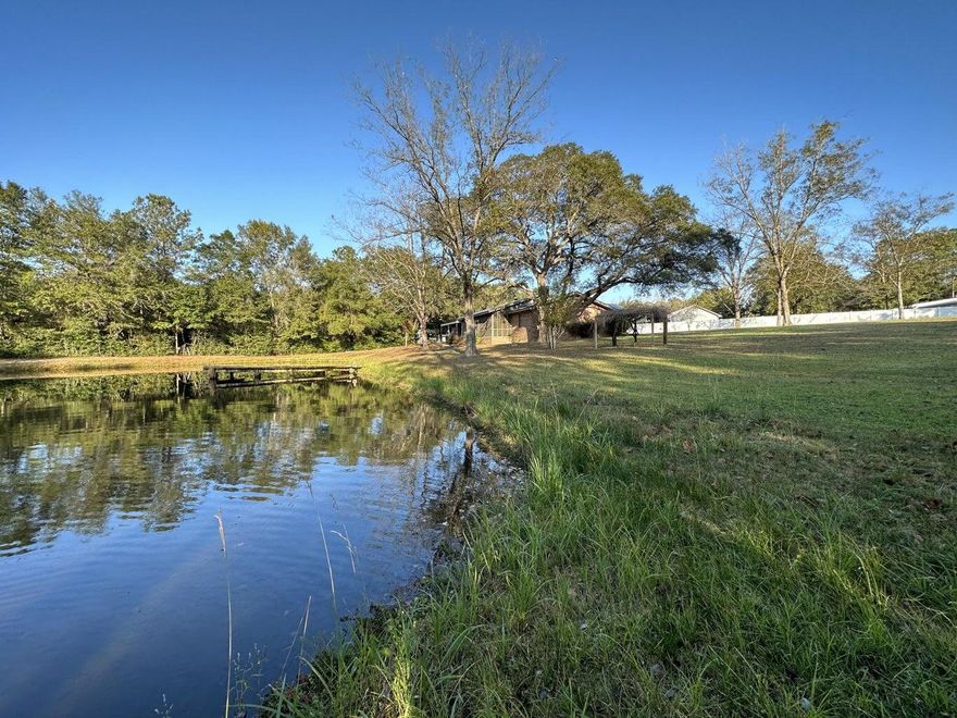 Experience the best of both worlds with this stunning all-brick 3-bedroom, 2-bath home offering peaceful country living just minutes from town! Enjoy county zoning with no city taxes on 4.65+/- beautiful acres surrounded by majestic oak and pecan trees. The property features a barn, workshop, covered storage areas, and even a crystal-clear pond stocked with bream and bass--perfect for relaxing afternoons or outdoor adventures.Inside, you'll find a spacious living area centered around a cozy wood-burning fireplace, ideal for gathering with family and friends. The home includes a main kitchen and an additional canning kitchen in the laundry area for extra convenience. The master bedroom offers a garden tub, walk-in shower, and double vanity, providing a peaceful retreat. Step outside to the screened-in porch or open grilling porch overlooking the pondan ideal space for entertaining or enjoying quiet country sunsets. Recent upgrades include a new roof, hot water tank, and updated A/C system.
With plenty of space for your boat, RV, tools, and toys, this property combines rural charm, modern updates, and unmatched convenience. Don't miss the chance to make this slice of country paradise your home!