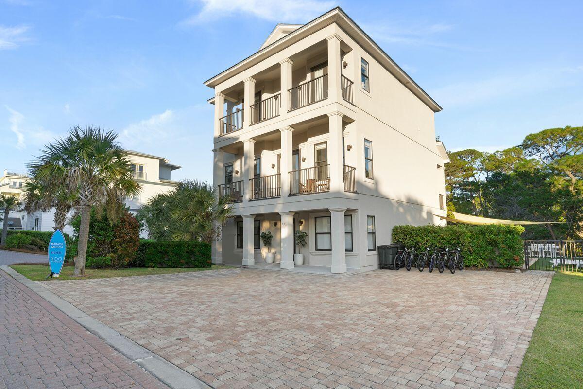 Luxury Coastal Residence With Pool And Putting Green! This imposing coastal home is situated on an oversized lot with expansive paved frontage providing ample parking. Contemporary designer interiors are matched by the exterior columned facade with covered porches. The private elevator provides access to all three levels. Six oversized bedroom suites, including three on the first floor, make it very easy to entertain family and friends in opulent style. The open floor plan on the second floor continues to impress with a capacious living area. It boasts wood flooring, a formal dining area and a chef's kitchen with breakfast bar for snacks and pre-dinner aperitifs. Custom cabinetry, quartz counters and a range of high-end appliances show that no expense was spared in fitting out this