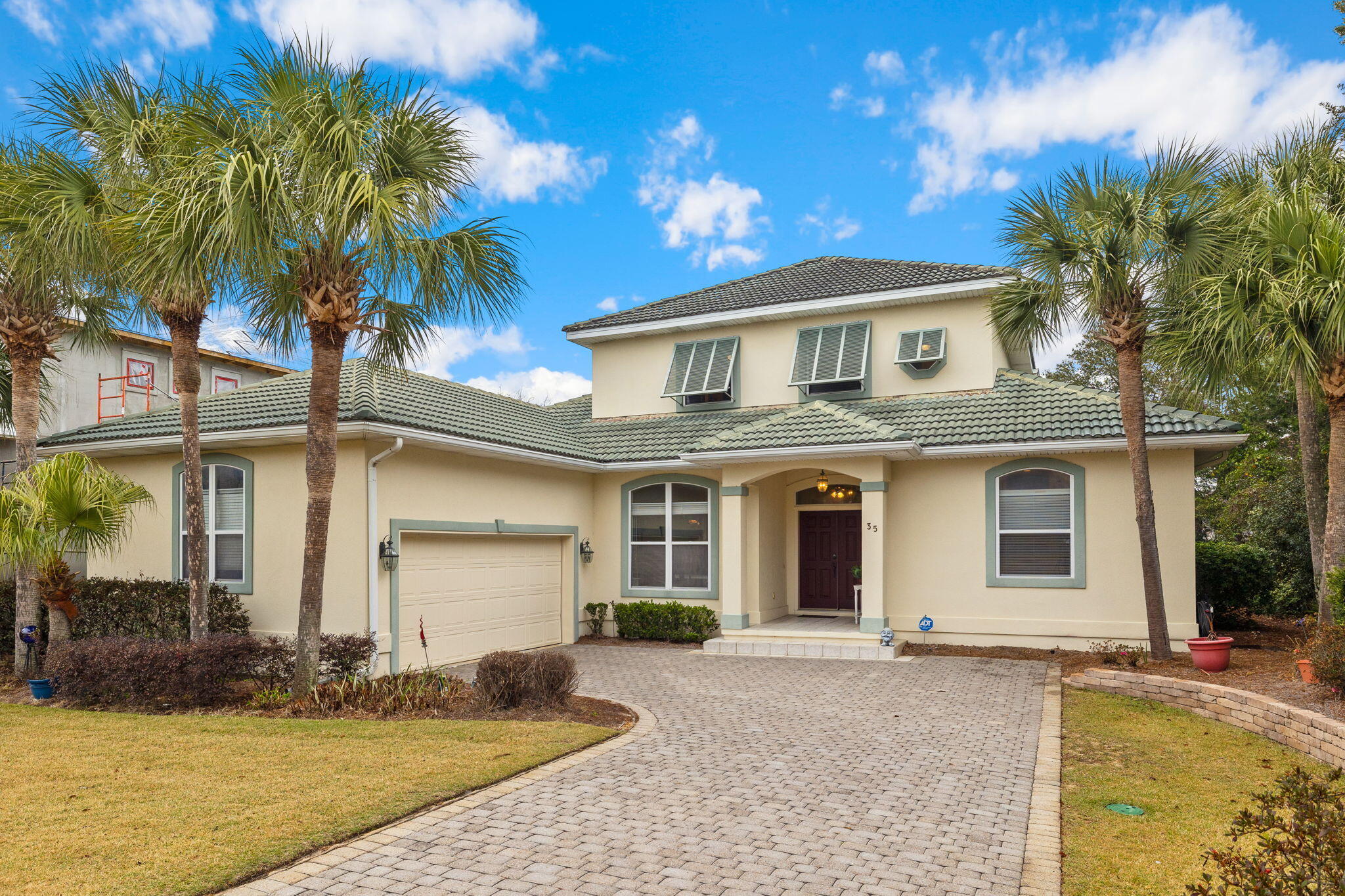 Aptly named for its location on Tranquility Lane in the prestigious gated community of Destiny East, this spacious, 2800+ square foot home offers owners an optimum coastal retreat with four bedrooms and four baths spanning two stories within a half mile from the white sands and aqua waves of the Gulf of Mexico. The first floor is thoughtfully designed with natural light flooding the open floor plan with integrated living, dining, and kitchen space. The kitchen boasts stainless steel appliances, a wine fridge, walk-in pantry, and two islands - one with generous prep space and the second with convenient bar seating.