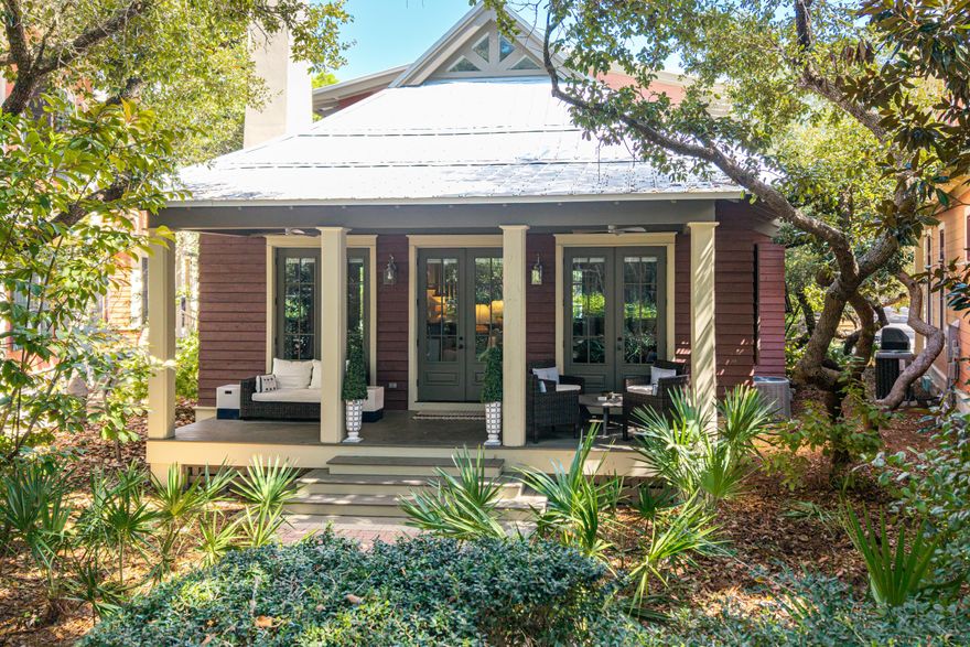 Tucked along Crimson Park in the Park District of Phase 1, this WaterColor cottage enjoys one of the most delightful addresses in the community--every home on the park is painted the color of a rose, creating a storybook streetscape you won't find anywhere else. Step inside and it feels as though you've walked straight into a Serena & Lily showcase, where thoughtfully curated furnishings set the stage for a chic coastal retreat that's casual and relaxed, yet stylish and refined.  With more than 1,700 square feet, this two-bedroom plus bunkroom, two-and-a-half bath home is designed for gathering, entertaining, and unwinding. Cathedral and beamed ceilings soar overhead, while oversized windows and three sets of French doors invite sunshine in and frame postcard-worthy views of Crimson Park and the Rose Garden Mews.
The first-floor owner's suite features a spa-like bath with dual vanities and opens onto a private screened porch, perfect for morning coffee or evening cocktails. A cozy first-level bunkroom adds charm and convenience, while the spacious upstairs loft with two queen beds lives like a full two-bedroom suite, making it easy to host family and friends in comfort.

Offered fully furnished and complete with a six-seat golf cart, this home is truly turn-key. Stroll to the Boathouse pool, the WaterColor Beach Club, or the Gulf in just minutes. Along the way, enjoy all of WaterColor's five-star amenities, multiple pools, tennis and pickleball courts, a fitness center, scenic trails, and the boathouse with paddleboards and kayaks waiting for your next adventure on Western Lake. This is coastal living at its most fun, most beautiful, and most unforgettable.