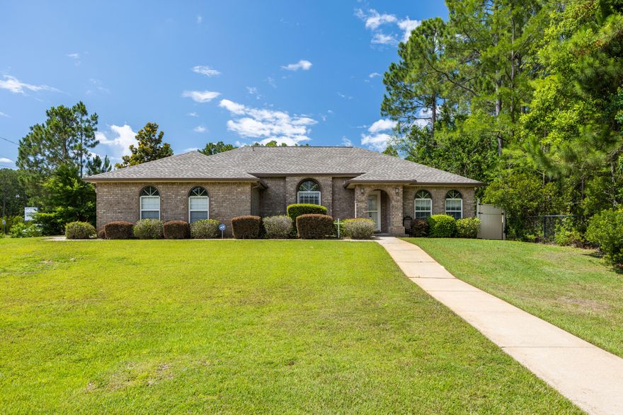 Custom built in 2006 by Fisher Homes, this beautiful one owner home has been meticulously cared for.  The 1,737 square foot home sits on an oversized .64-acre corner lot and is ideally located as it is close to local military bases, the sandy beaches of the Gulf Coast, and A rated schools. The bright and airy 3-bedroom 2-bath split-floor plan has tile and wood laminate floors throughout, custom wood cabinetry with granite counters, and spacious living and bedroom areas.  In addition, a flexible Florida room makes a great home office, gym, or playroom.  Outside, you will enjoy a large, fenced back yard with a storage shed for housing lawn equipment, bikes, and other outdoor games.  The home has a newly installed back fence, new garage door opener unit with controls, and newer roof (2024). Inside you will find plenty of closet and storage space. The home is also wired for surround sound with speakers throughout the house.  The seller has the original floor plans and has kept a termite contract in place since purchasing the home in 2006.  Storm protection panels for the windows are located in the shed.  

As a resident in one of Navarre's most desirable neighborhoods, Holley By-The-Sea, you'll enjoy membership in an impressive multi-million dollar recreational and clubhouse facility that includes: 3 pools, sauna and steam room, gym, tennis and pickleball courts, community room, playground, softball field, track, basketball courts, deeded access to Santa Rosa Sound with a private pier, boat/kayak launch, sandy beach, picnic pavilions, and RV parking.