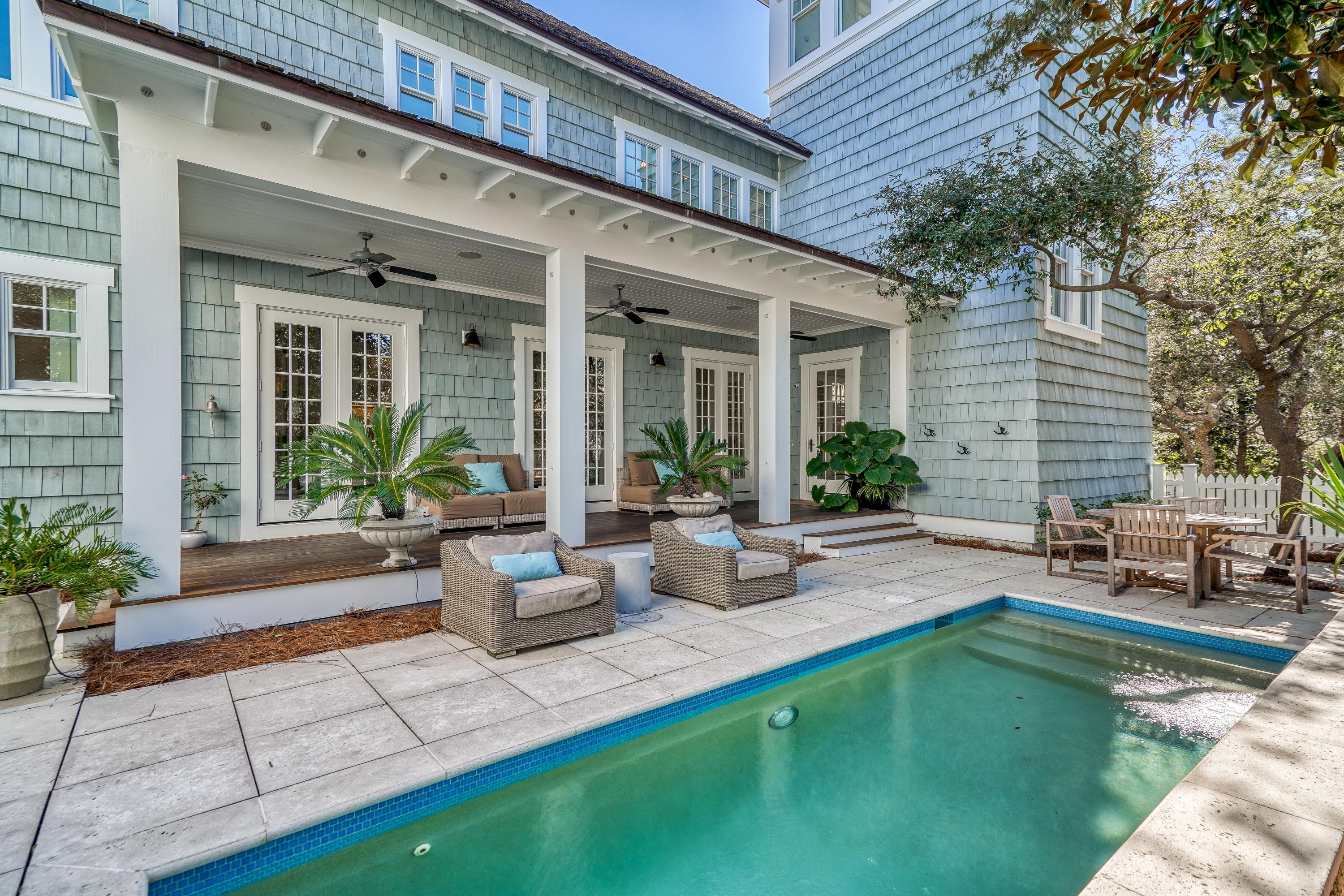 Bright sunlight streams into impeccably designed spaces at this custom WaterSound Beach masterpiece. Designed by Geoff Chick & Associates, this stunning residence is just steps from the Gulf of Mexico.The larger corner location allows for multiple outdoor spaces including three covered porches which create idyllic places to soak up the warm Gulf breeze.Luxury finishes & features were carefully selected to embody a classic coastal style including recently refinished reclaimed pine floors, shiplap walls, coffered ceilings & upgraded lighting. The chef's kitchen is beautifully appointed with professional-grade appliances, marble countertops & new custom stove hood. Vaulted ceilings, a tabby shell fireplace & the multitude of windows allow in the natural light highlighting the living room.