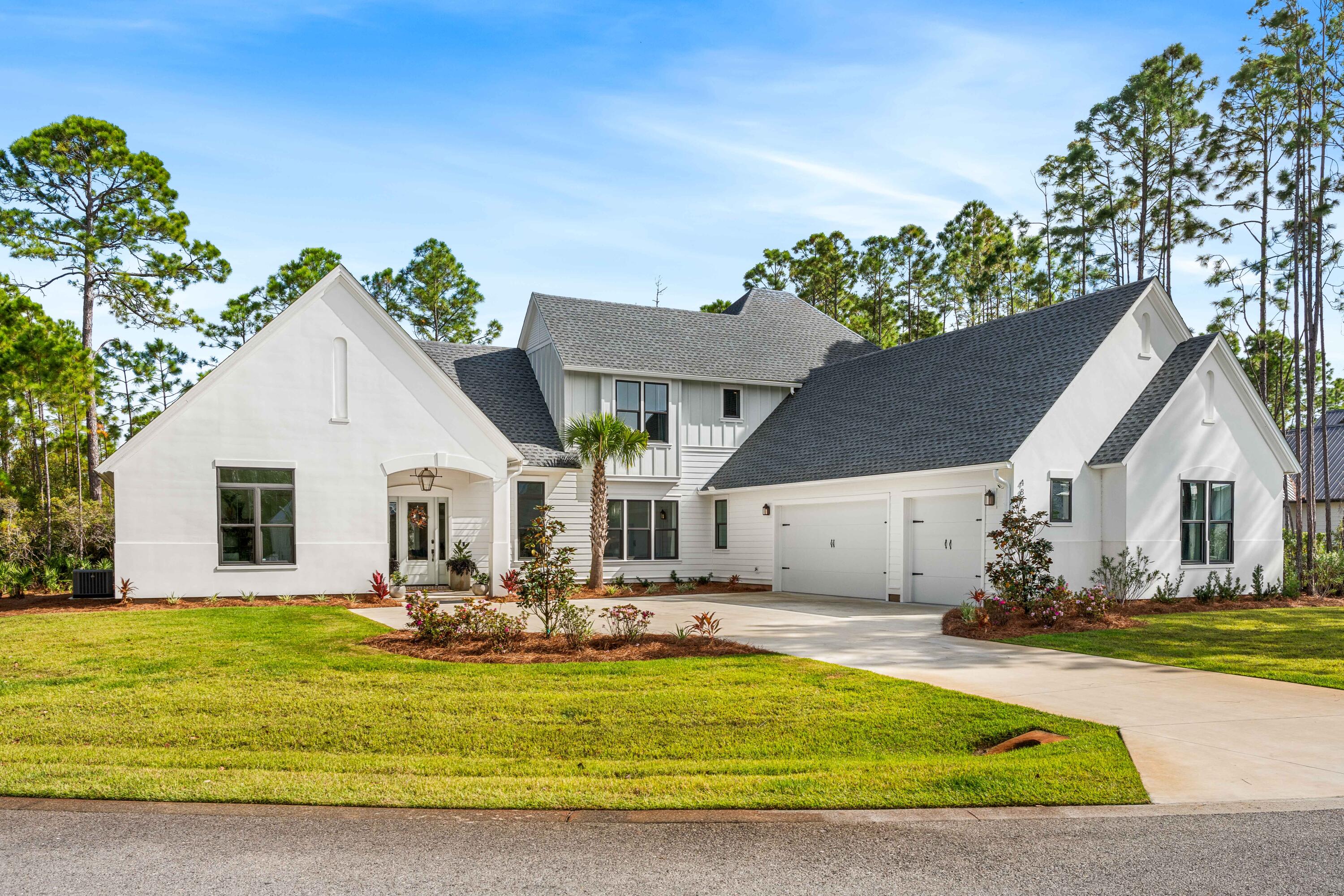 Welcome to 489 Hideaway Circle, an exquisite like-new 2023-built masterpiece nestled on a serene half-acre lot within the prestigious gated bayfront community of Seclusion Bay in Santa Rosa Beach. This luxurious home boasts 5 bedrooms, including both upstairs and downstairs guest suites, offering exceptional privacy and comfort for family and friends.Thoughtfully designed with high-end finishes, this residence features white oak hardwood flooring, quartz countertops with waterfall edges on the island, and premium stainless steel appliances. The main floor includes a separate wet bar and a butler's pantry--perfect for entertaining. Upstairs, a secondary gathering space on the landing creates a versatile retreat, while pops of designer wallpaper throughout add a touch of personality... and warmth. Enjoy movie nights in the dedicated theater room or take advantage of the expansive backyard with ample room for a custom pool. Abundant natural light floods the living spaces, creating a peaceful and welcoming atmosphere throughout. And the three-car garage even includes a conditioned storage closet for added convenience. This low-density, family-friendly community is comprised of only 53 estate-sized lots, ensuring a quiet, exclusive setting. Residents in Seclusion Bay enjoy access to a community dock on the Choctawhatchee Bay for fishing, paddle-boarding, and kayaking, along with mesmerizing bayfront sunsets- ensuring MAXIMUM family memories. Centrally located near 30A's renowned beaches, top-rated schools, and scenic state parks, this home delivers the absolute best of coastal living.