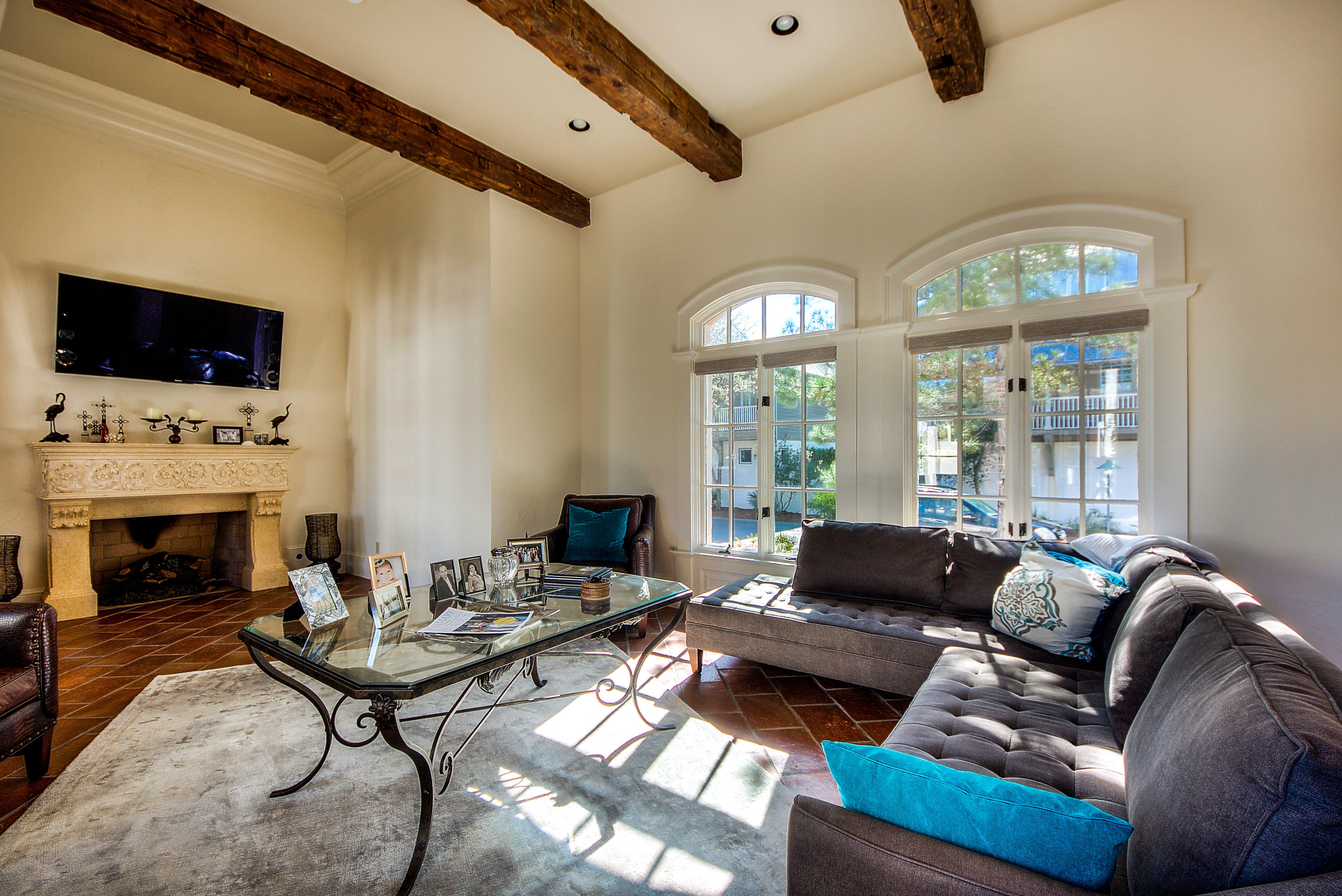 Furnished Courtyard style home with 3 bedrooms 3 1/2 baths on a large private homesite, Potential 4th bedroom carriage house over garage. Master on the main floor with French doors overlooking the courtyard and pool with additional French door access to large patio with pergola, grill space and fountain. Living room features 12' ceilings with wood beams and fireplace. French doors lead to a vaulted covered porch with wood burning fireplace overlooking private courtyard and pool. Kitchen has a large island with gourmet appliances, walk-in pantry and an open floorplan to include a casual dining area. This home with it's exceptional curb appeal is only steps away from the Rosemary Beach Amphitheater and owners pool.