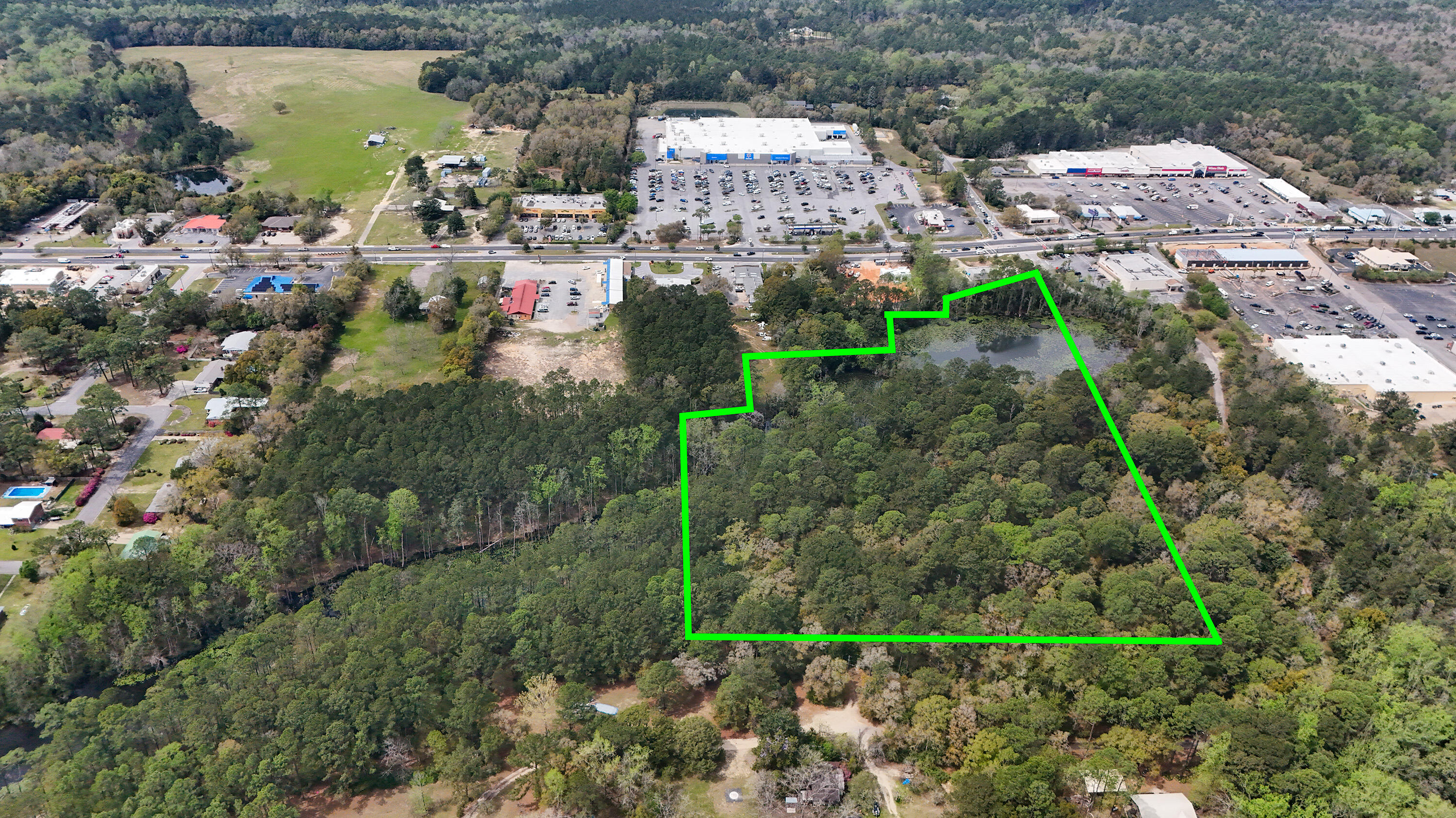 This exceptional 15 ACRE COMMERCIAL property, ZONED C2, is strategically located just off US HWY 331S, across from WALMART and less than 1 MILE NORTH OF I-10, in the rapidly growing area of DEFUNIAK SPRINGS, FL. With convenient traffic light access from Corbett Drive and clear visibility from 331, this property offers unparalleled potential for a variety of commercial ventures.Offering 15 ac +/- altogether, with approximately 10 ACRES UPLANDS (mostly level), plus additional natural features including a beaver pond and creek. C2 ZONING allows for diverse uses such as hotels/motels, apartments, retail stores, professional offices, banks, restaurants, auto dealerships and more. Easily seen from Hwy 331, the sellers have added an additional opportunity for a 331S MONUMENT SIGN. Flexible options include subdividing the property into 2, 3, or more parcels to suit your specific needs. Sellers are creative and willing to consider various, serious proposals. Whether you're looking to develop a single-use project or a mixed-use complex, this property can accommodate your vision. A completed HOTEL/MOTEL FEASIBILITY STUDY is available for review for serious buyers. With access to electric, city water and city sewer, this property is poised to be a project with the pieces of the puzzle needed for a straightforward start.
The natural features and layout of the property also provide numerous opportunities for landscaping and design. This is a rare opportunity to secure a prime piece of commercial real estate in a thriving market.
